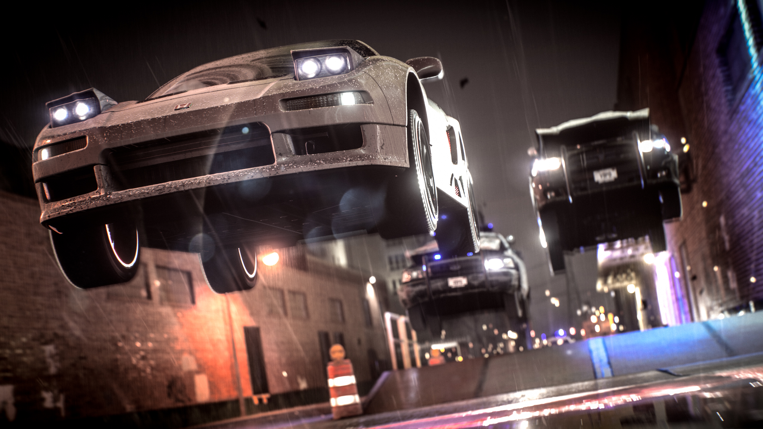 Cars jumping in a rainy city at night HD Wallpaper