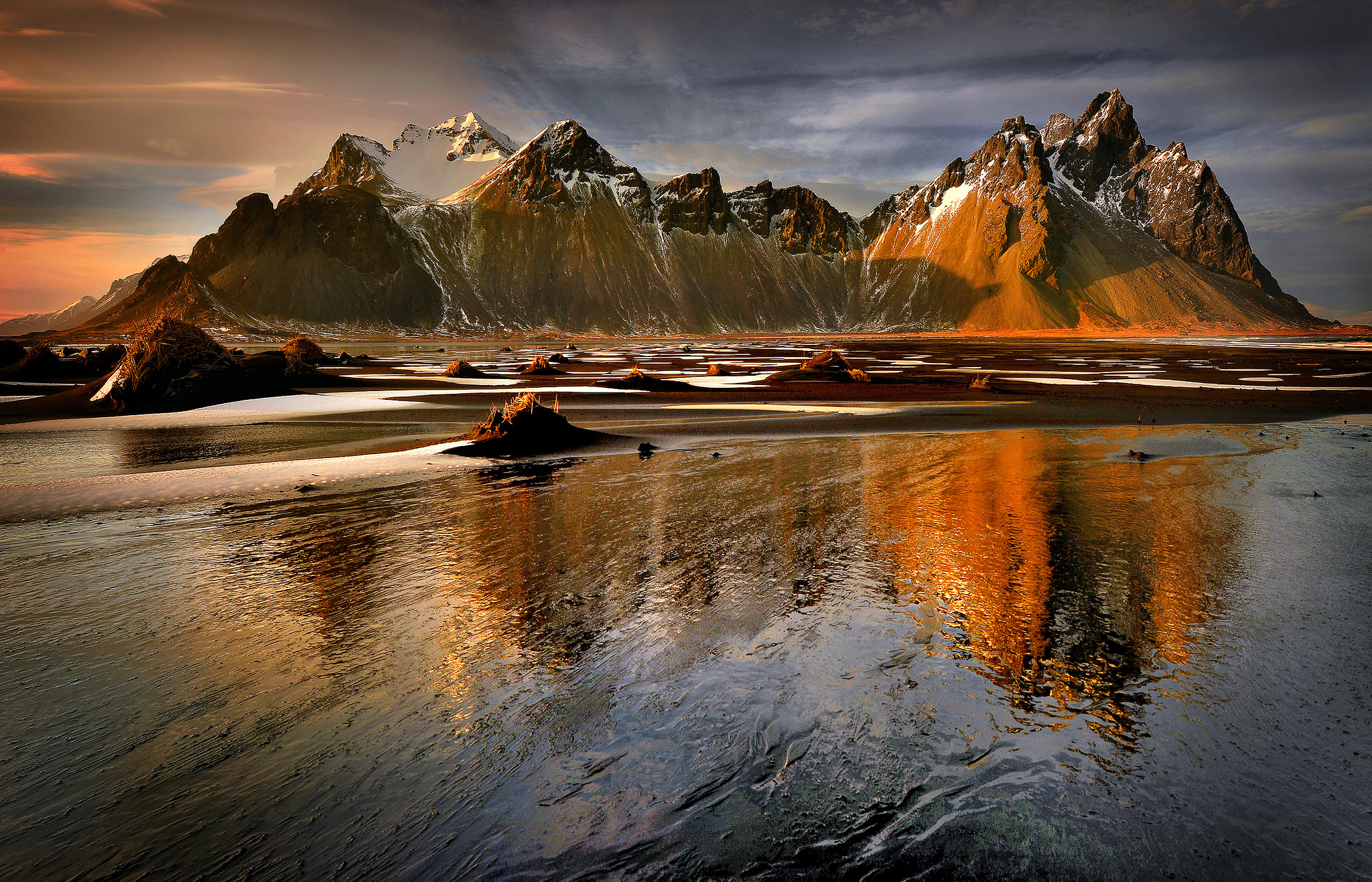 Mountain range reflection on a beach at sunset HD Wallpaper
