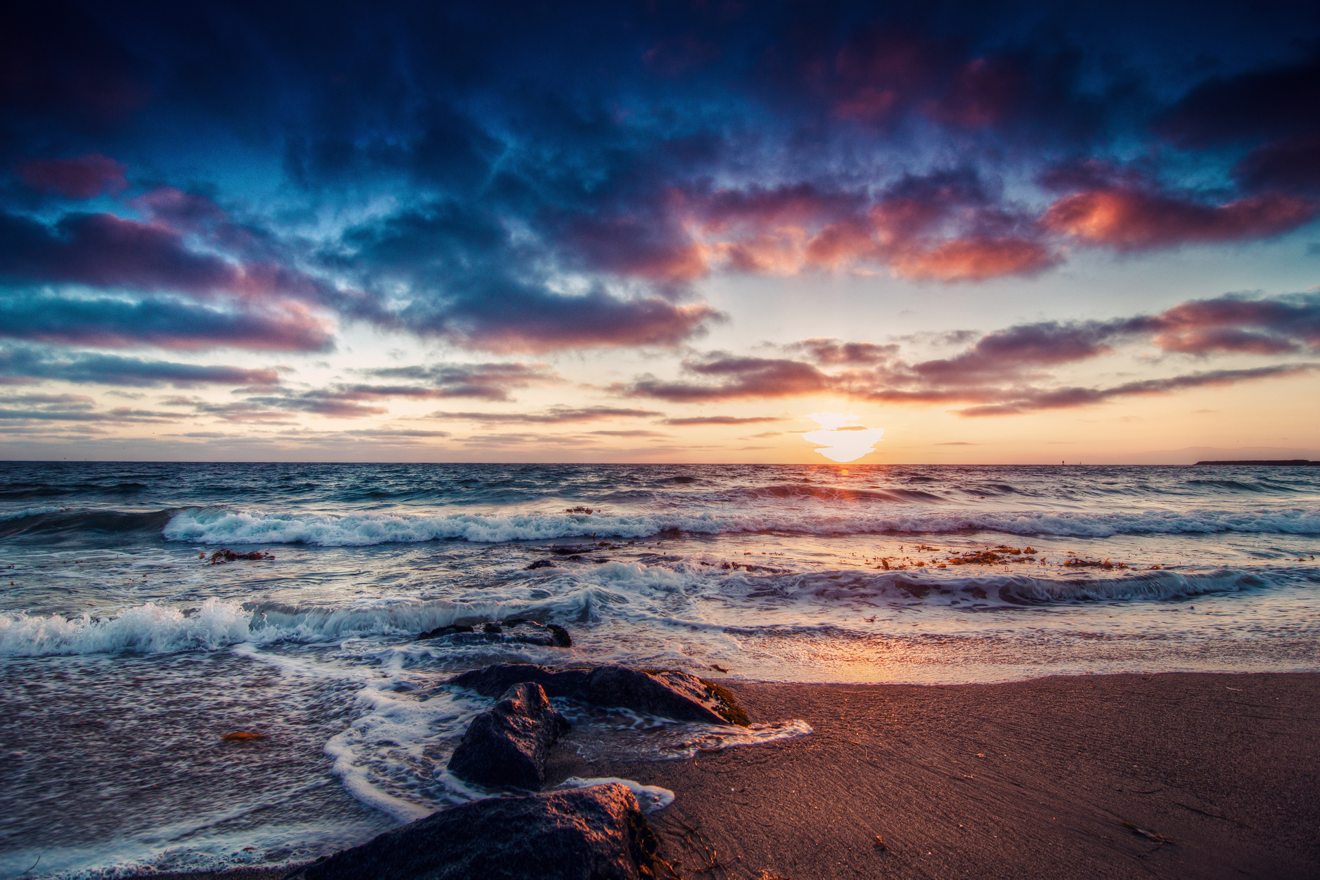 Sunset over the ocean with dramatic clouds HD Wallpaper