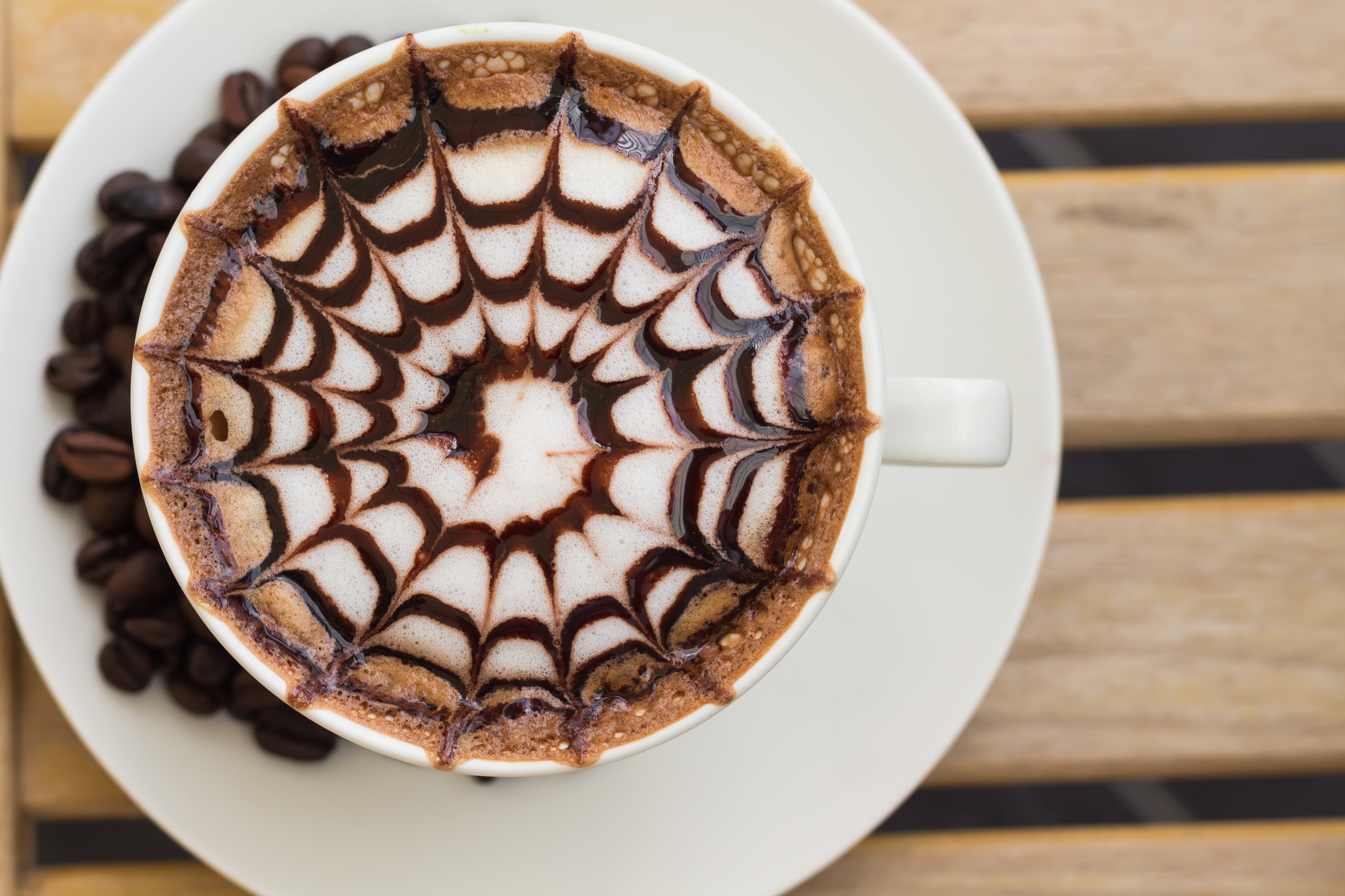 Coffee cup with latte art and coffee beans HD Wallpaper