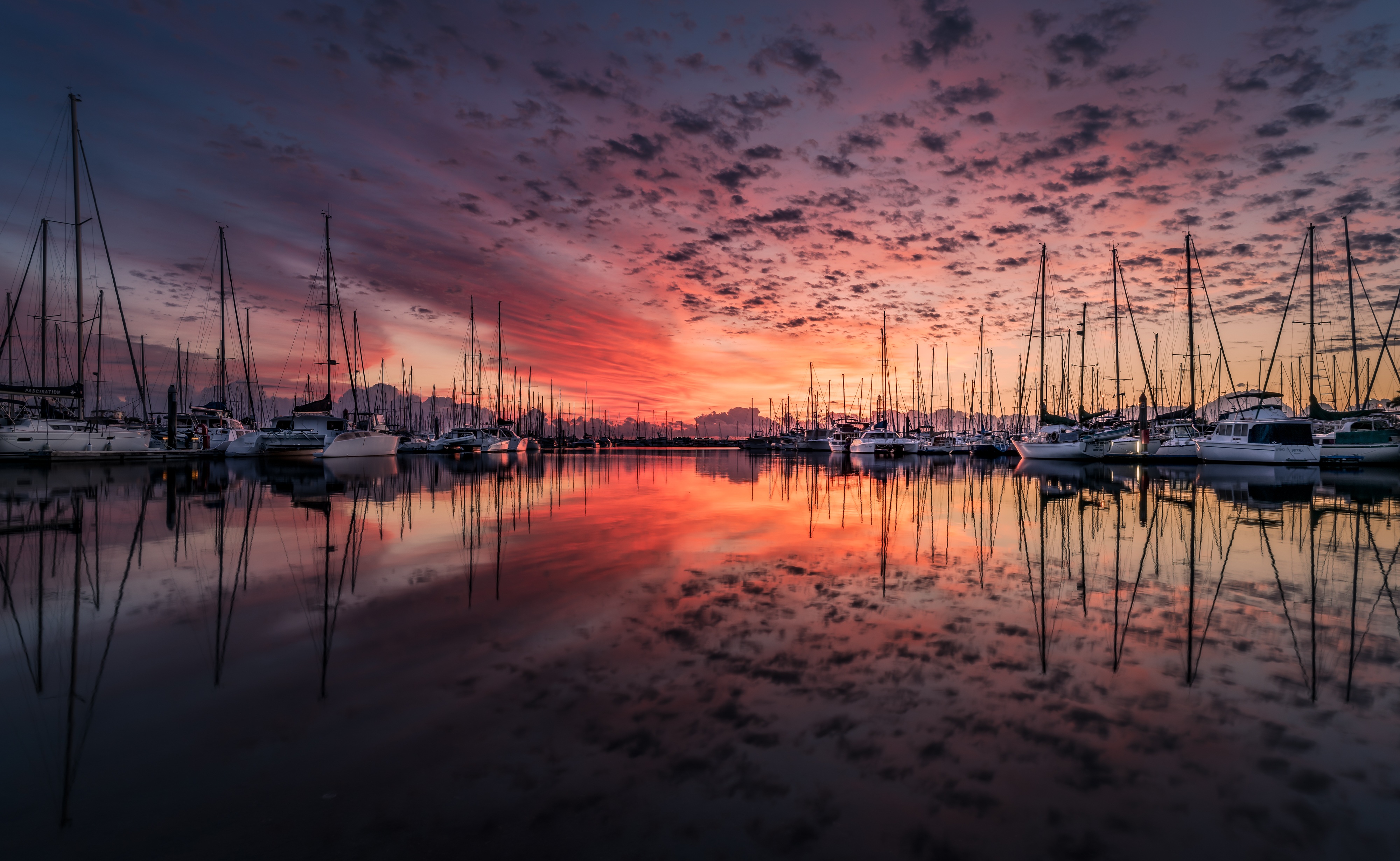 Sailboats in a harbor at sunrise with colorful sky and reflections HD Wallpaper
