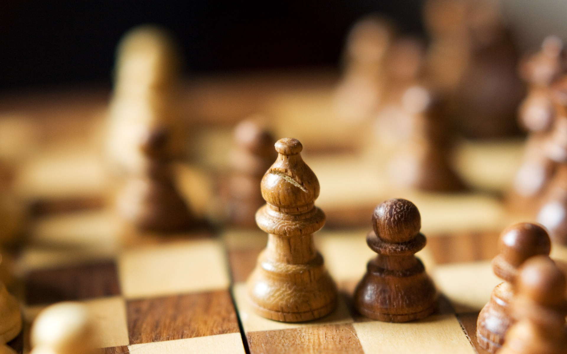 Chess game with wooden pieces on a board HD Wallpaper