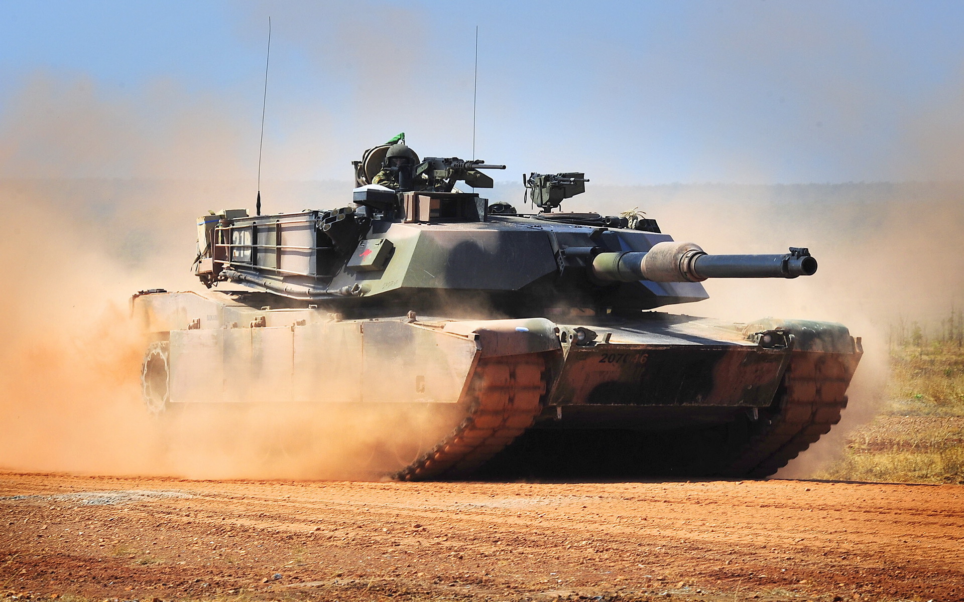 M1 Abrams tank in dust cloud HD Wallpaper