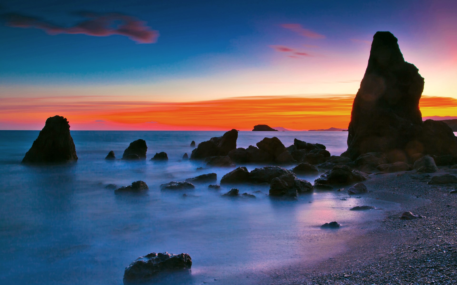 Rocky coastline at sunset with colorful sky HD Wallpaper