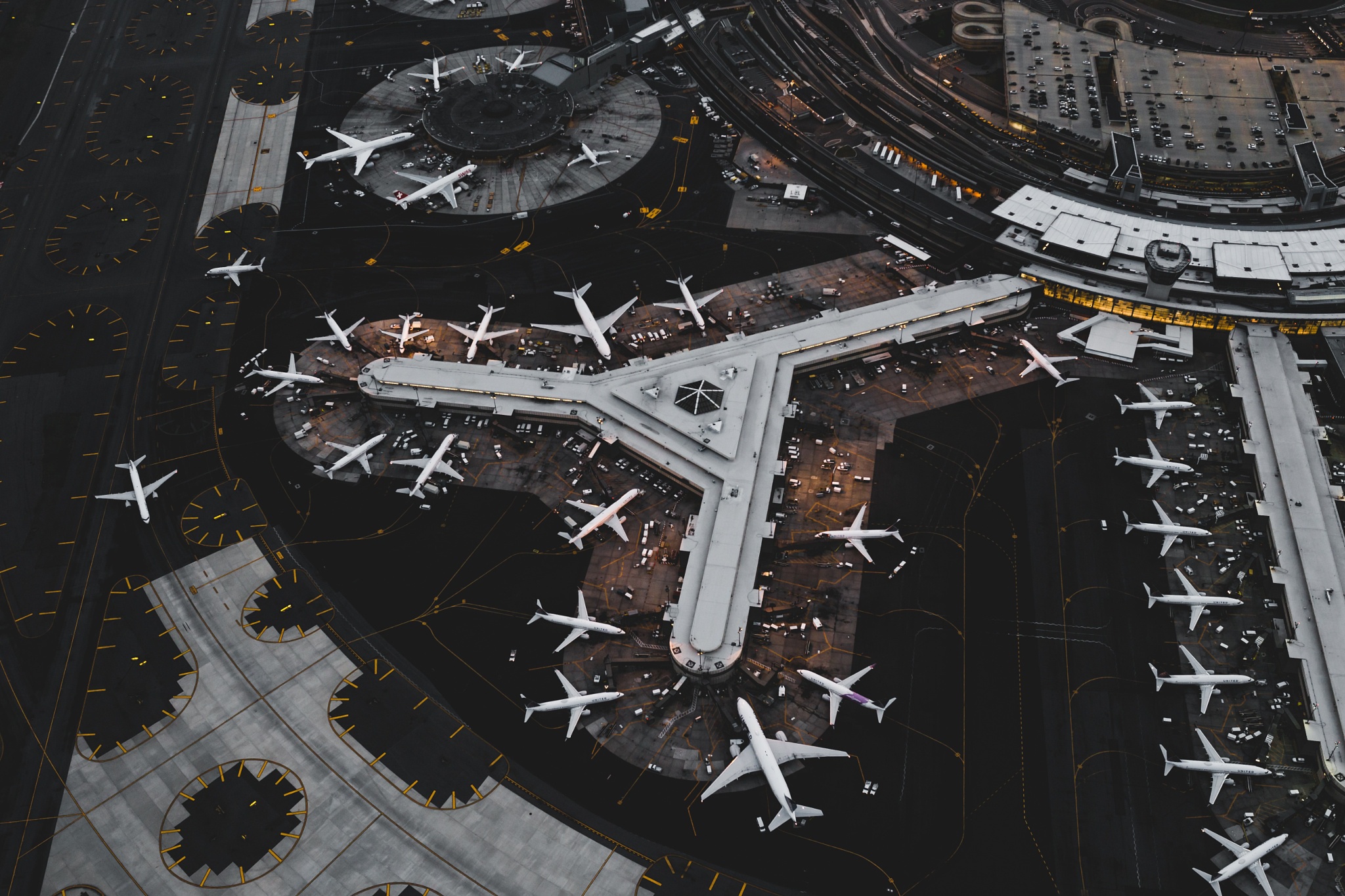 Aerial view of a busy airport terminal with many airplanes HD Wallpaper