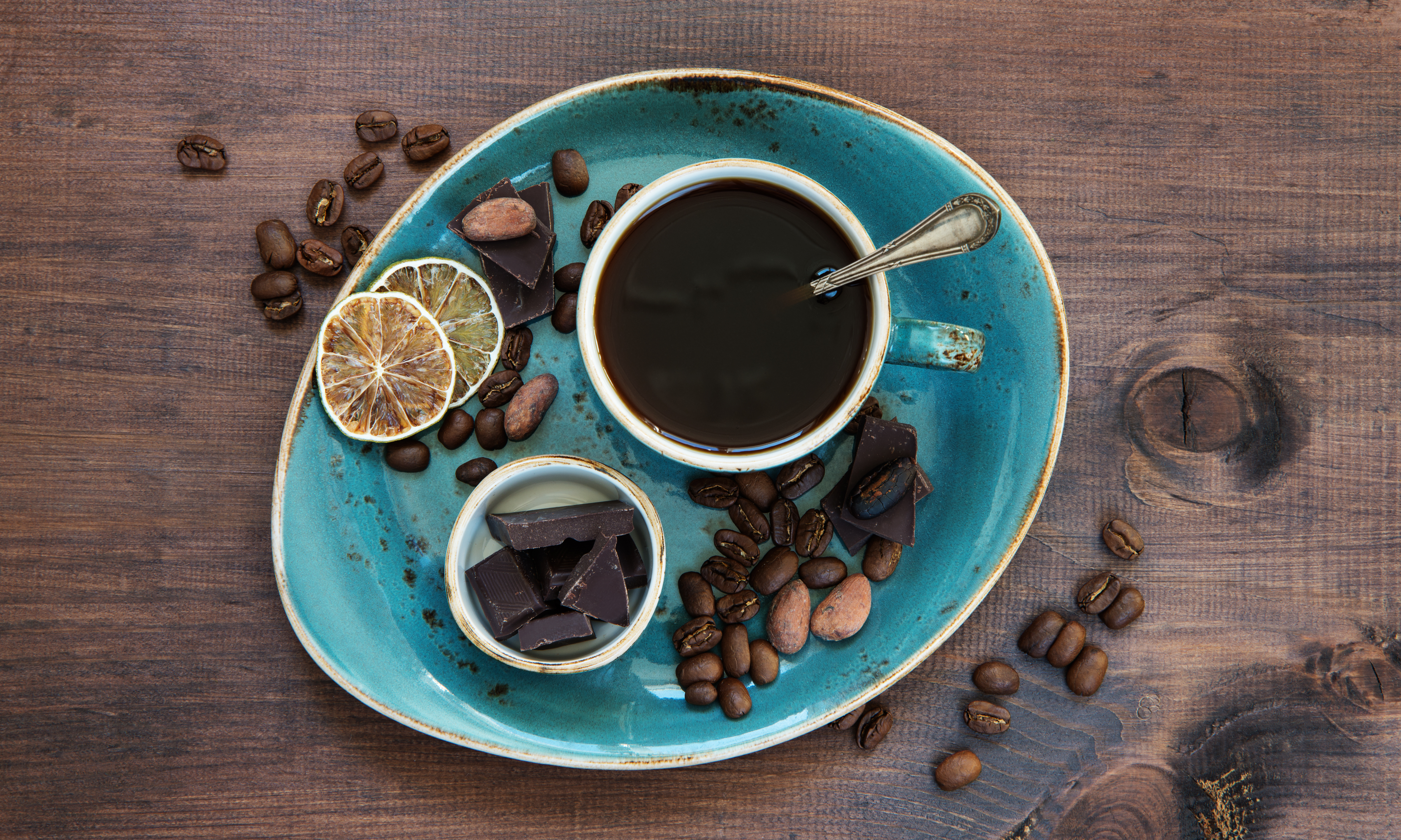 Coffee, chocolate, and dried lime slices on a plate HD Wallpaper