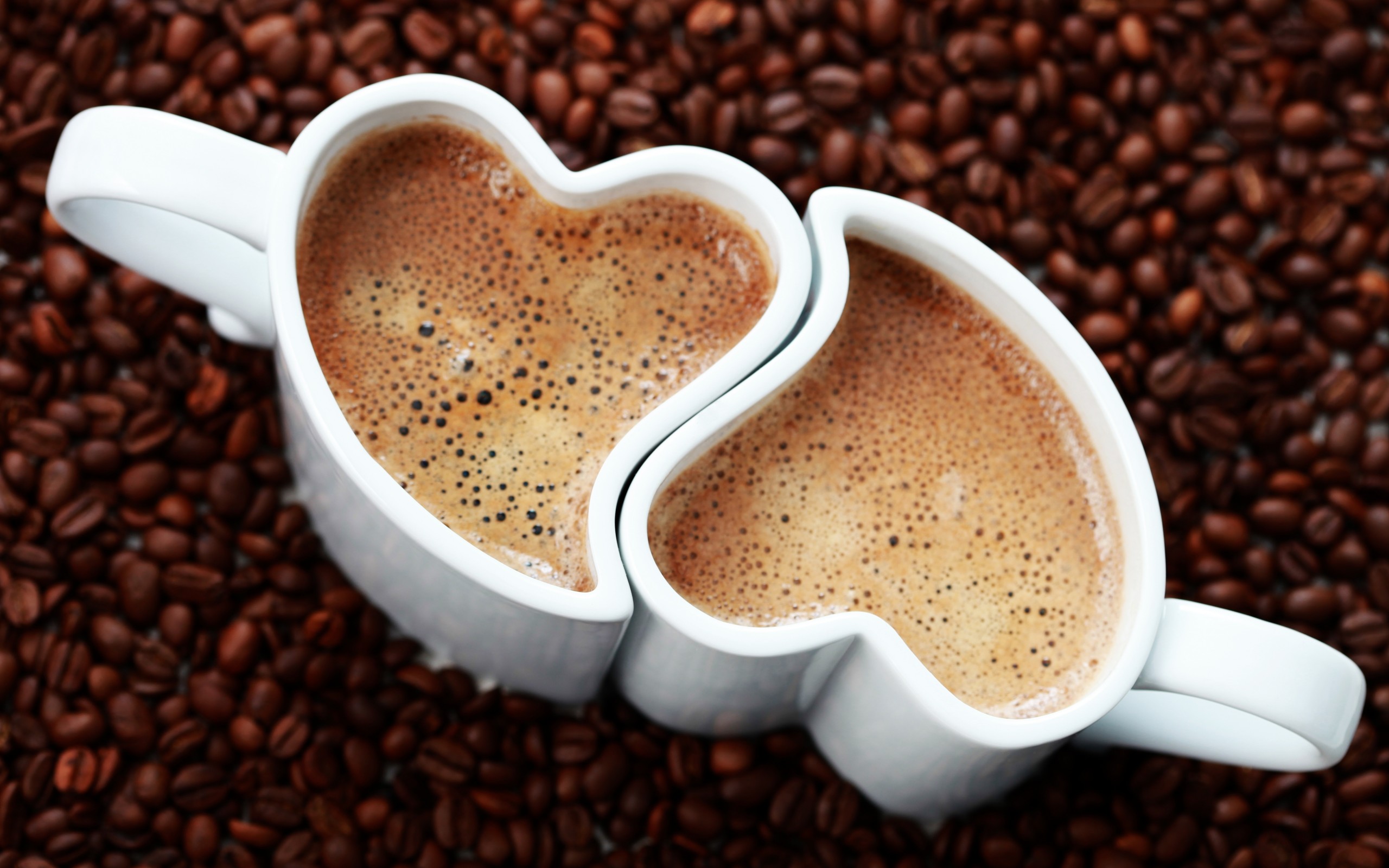 Two heart-shaped coffee cups filled with coffee HD Wallpaper