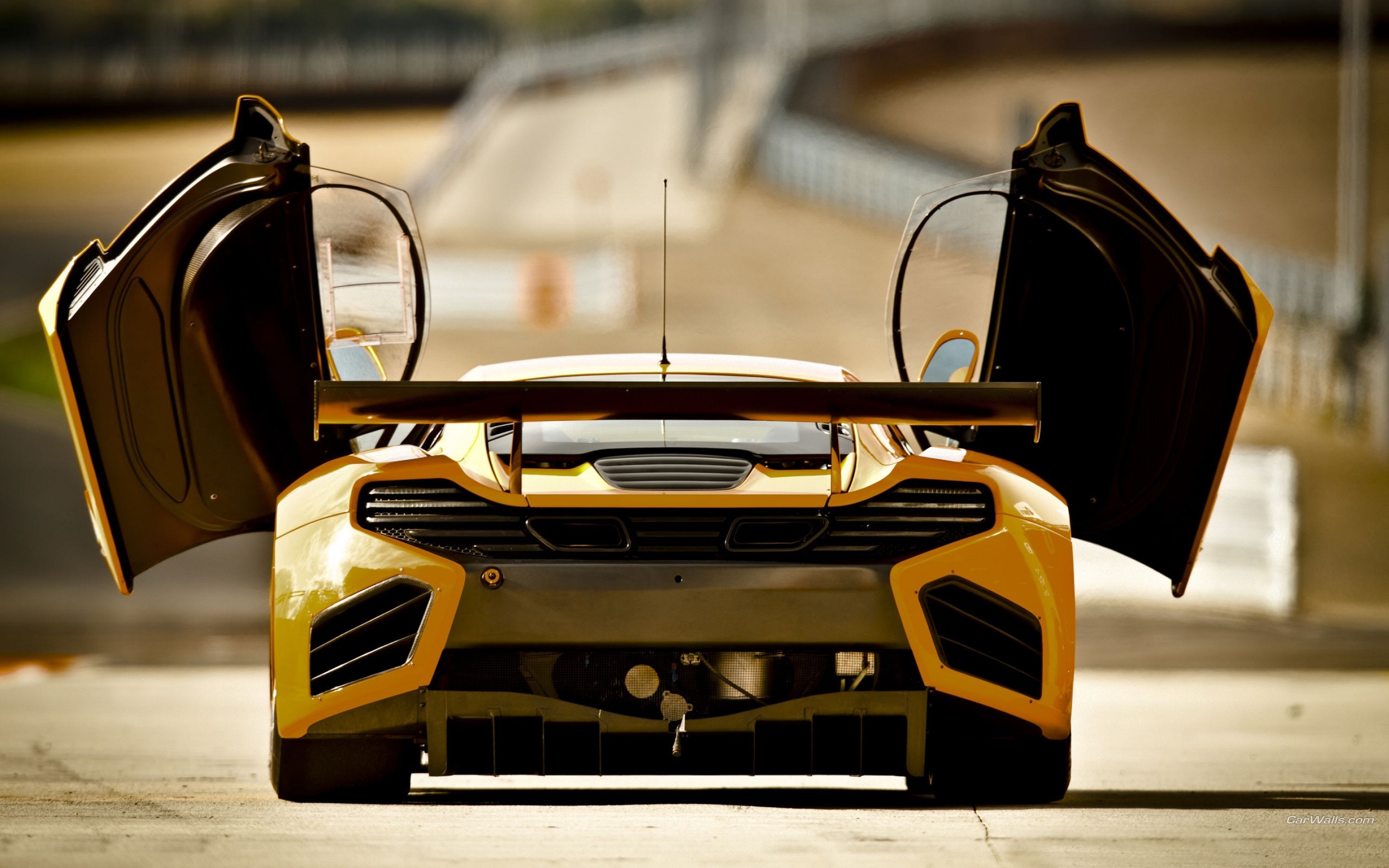Yellow McLaren race car with doors open HD Wallpaper