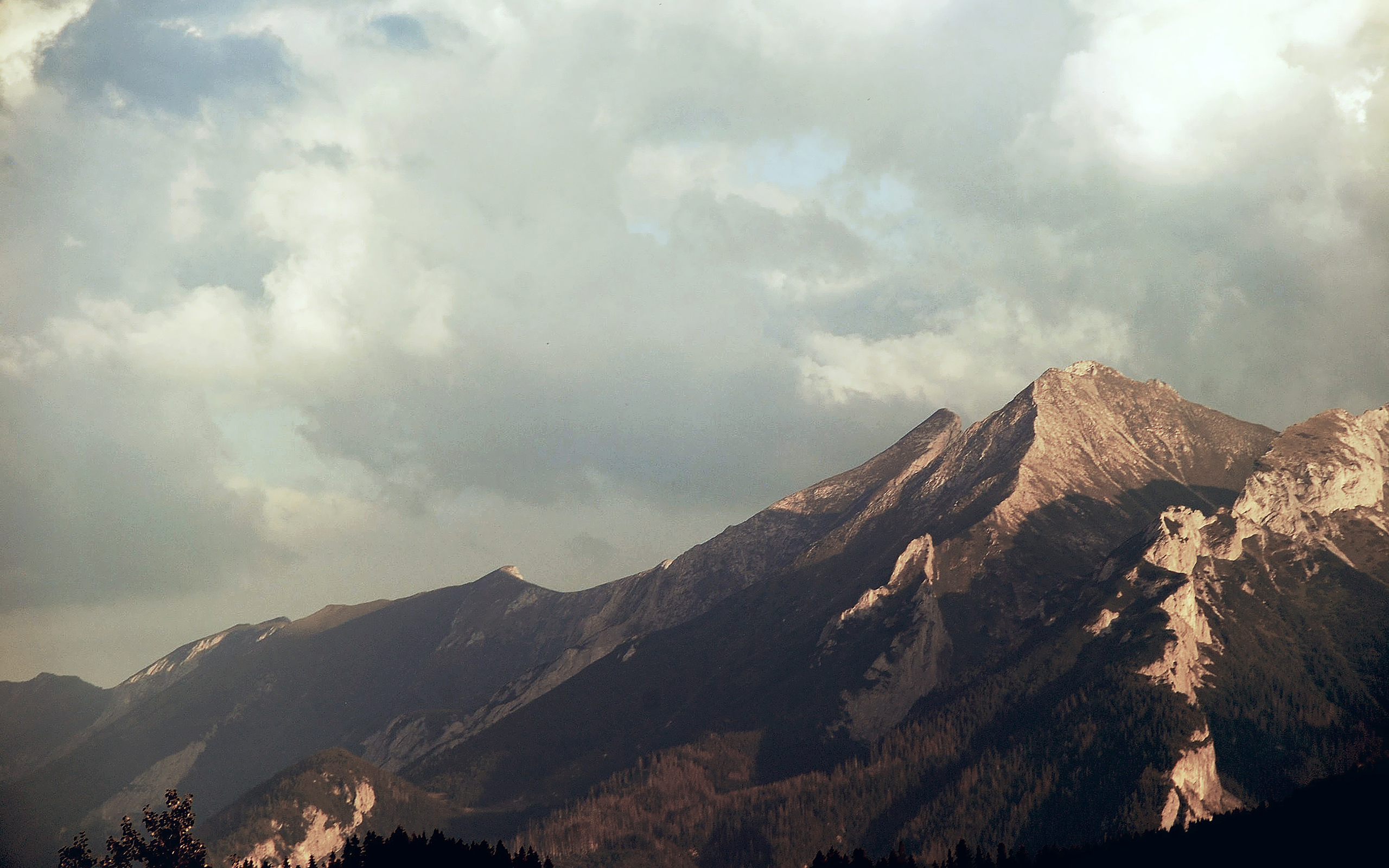 Mountain range under cloudy sky HD Wallpaper
