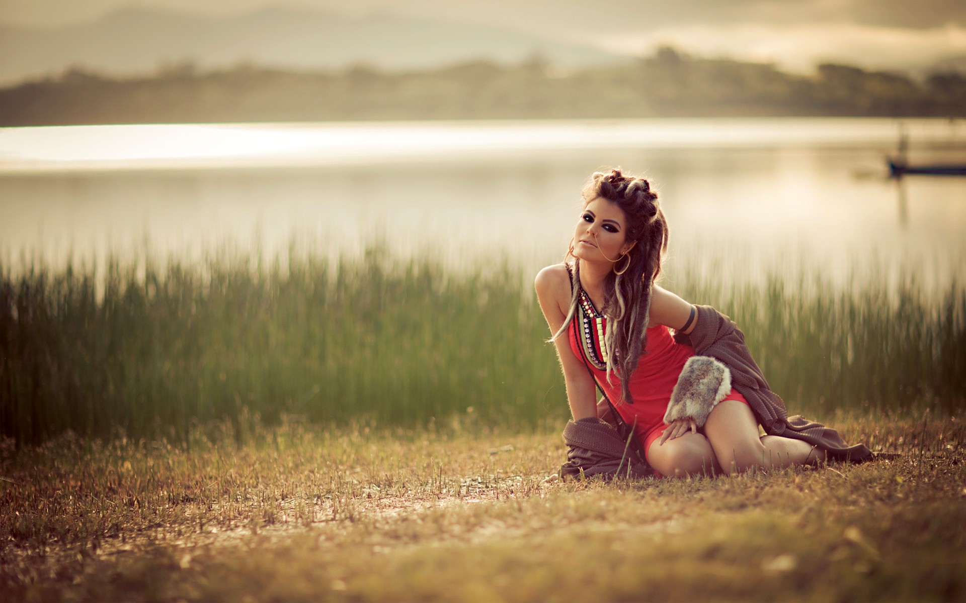 Woman with dreadlocks by a lake HD Wallpaper