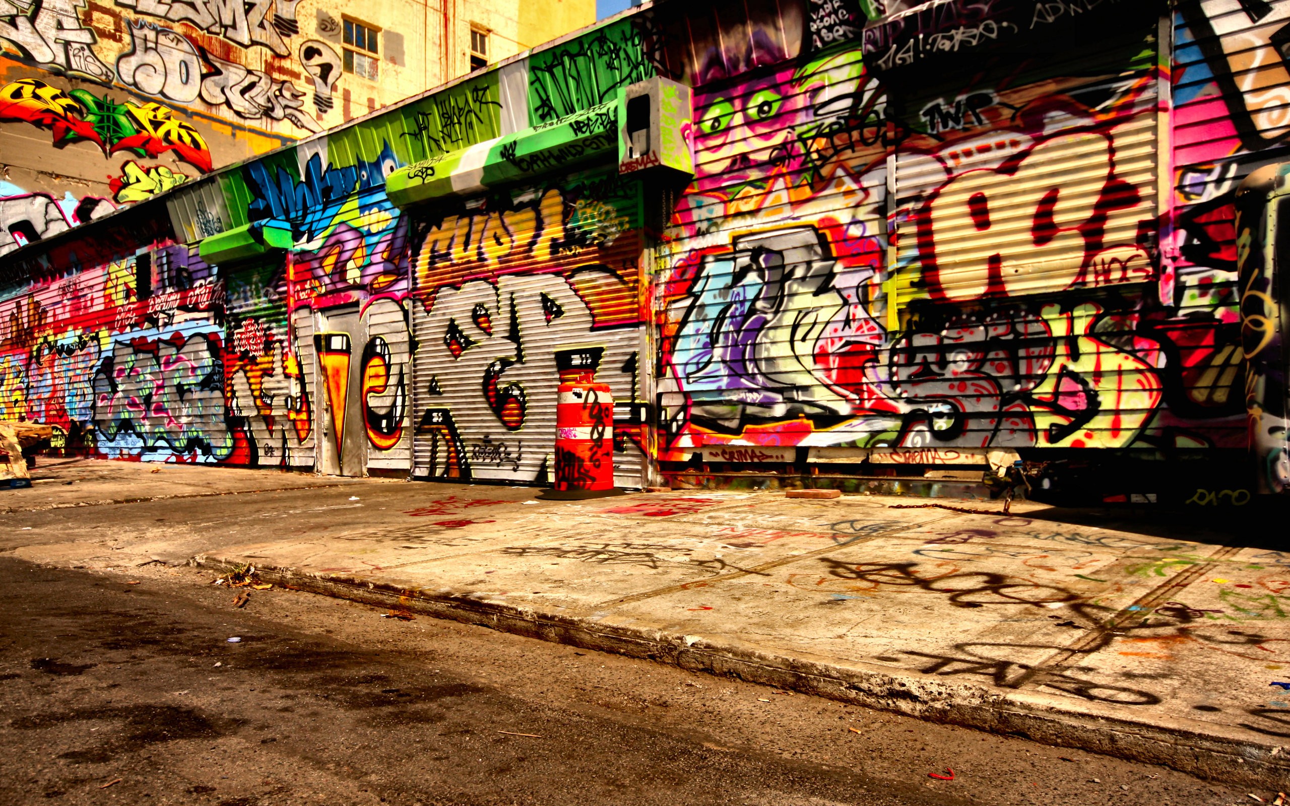 Graffiti-covered urban storefront and alleyway HD Wallpaper