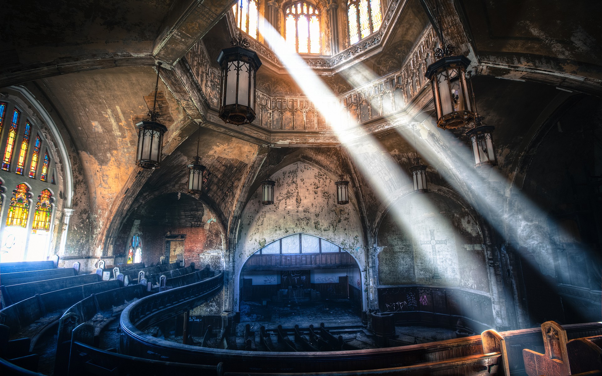 Abandoned church interior with sunbeams and stained glass HD Wallpaper