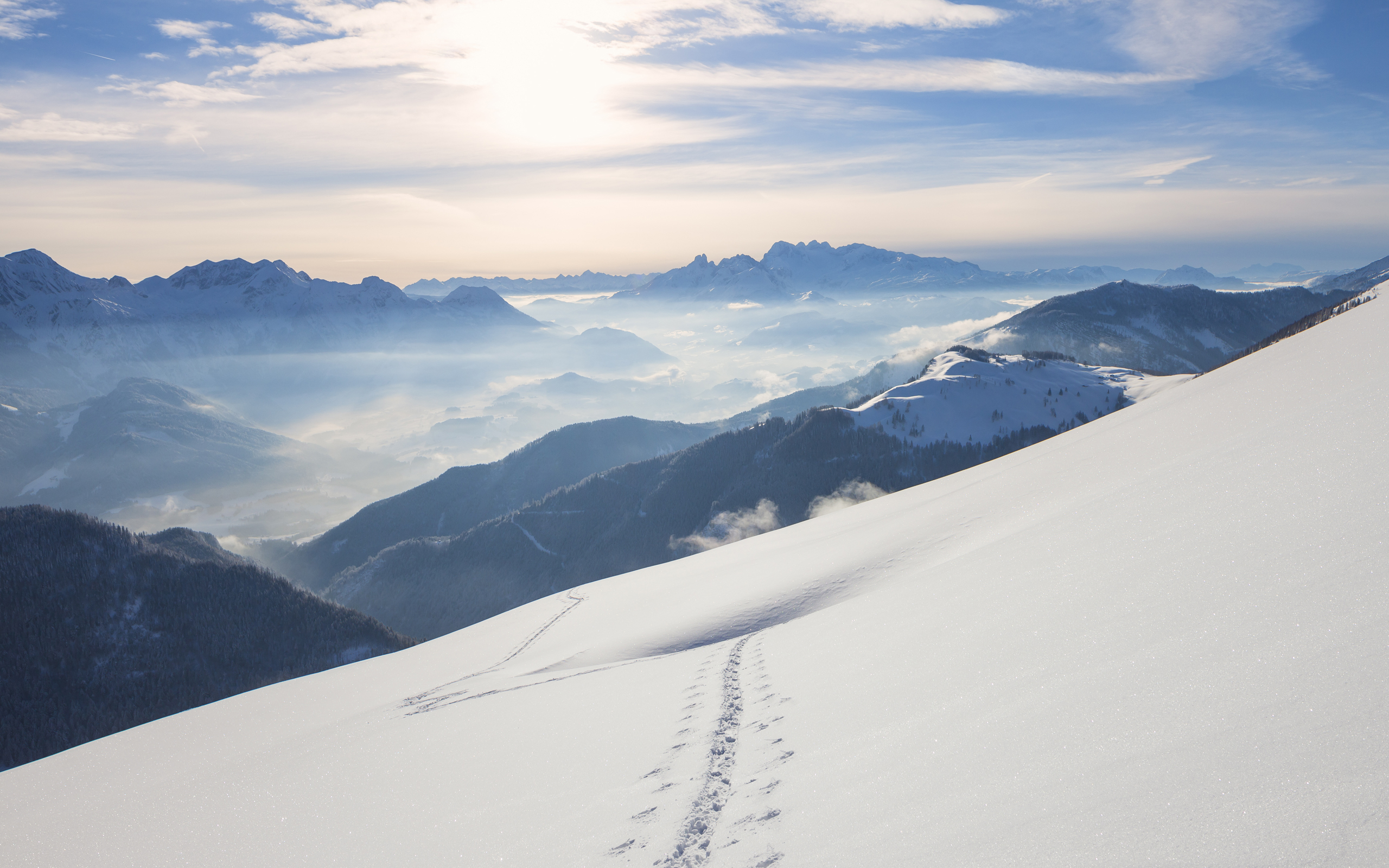 Snowy mountain landscape with fog in valleys HD Wallpaper