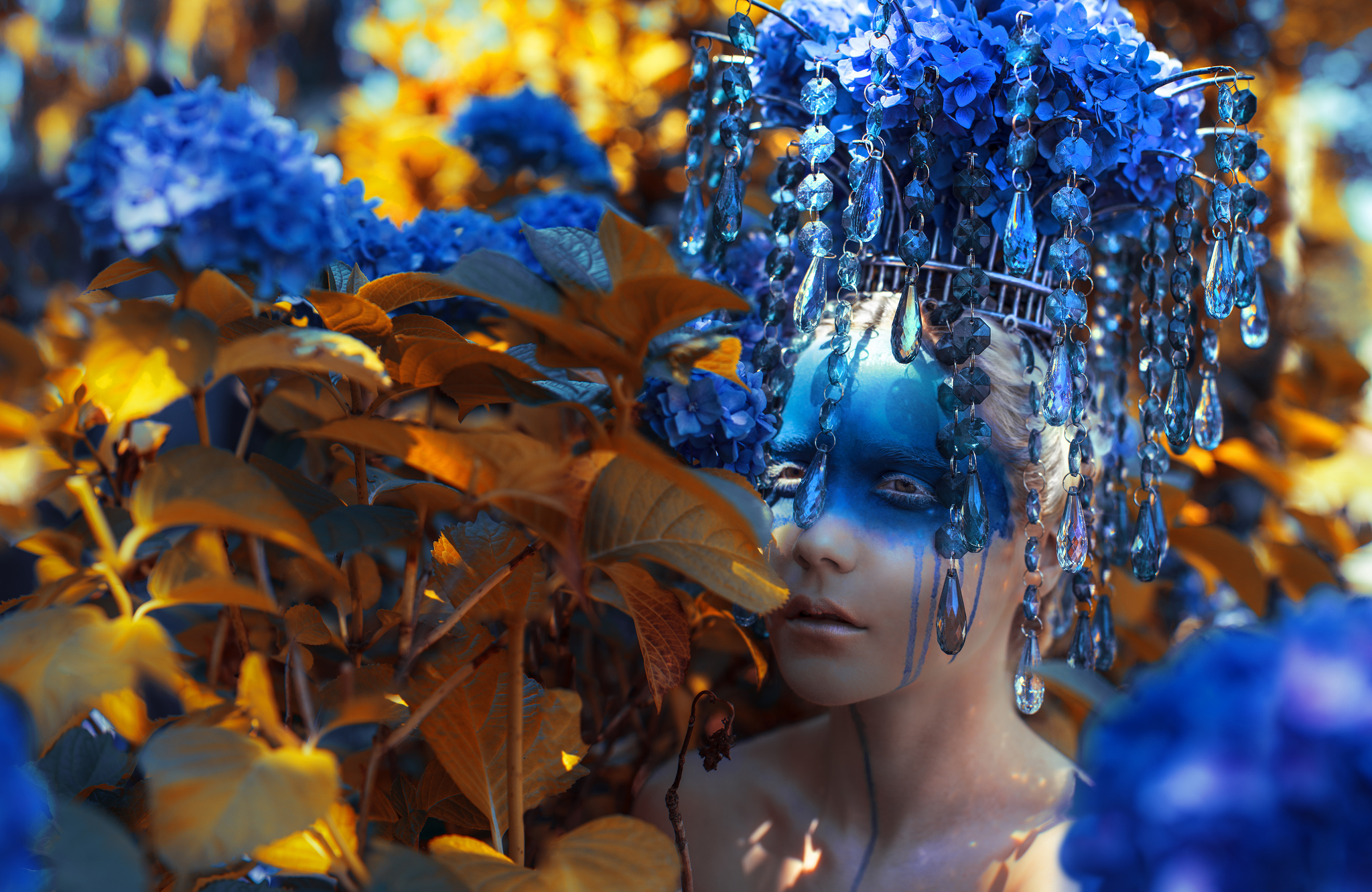 Woman with blue face paint and floral headdress HD Wallpaper