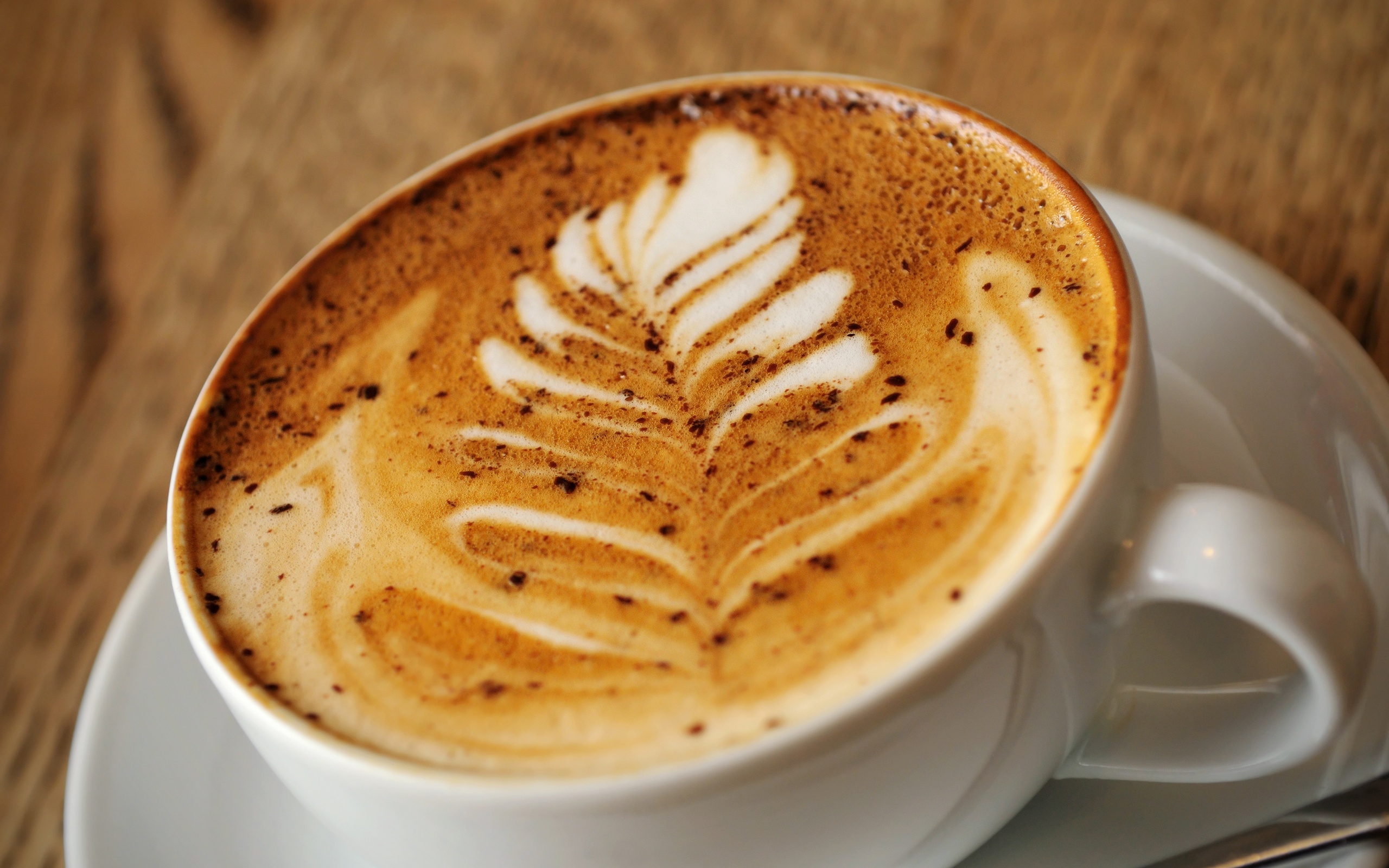 Latte art coffee in a white cup HD Wallpaper