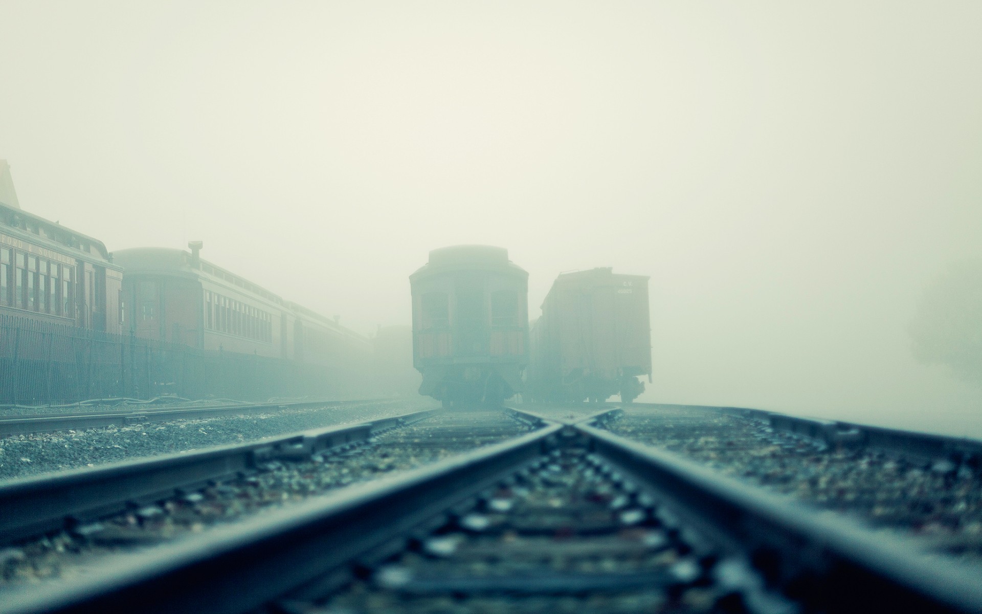 Trains on tracks in thick fog HD Wallpaper