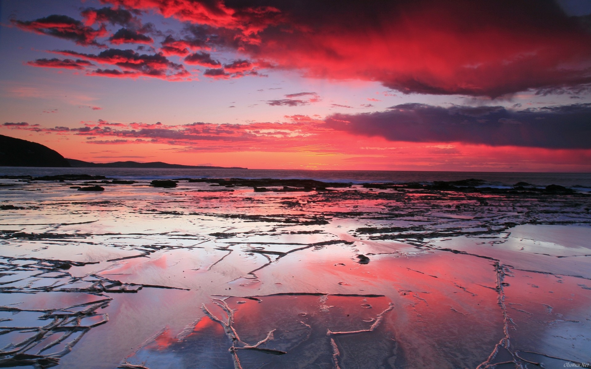 Sunset over rocky shore with red clouds HD Wallpaper