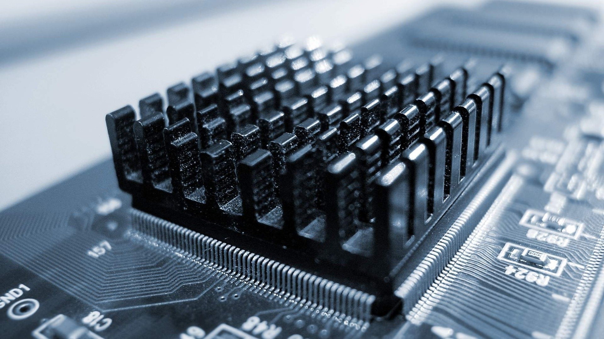 Close-up of a computer motherboard with a heatsink HD Wallpaper