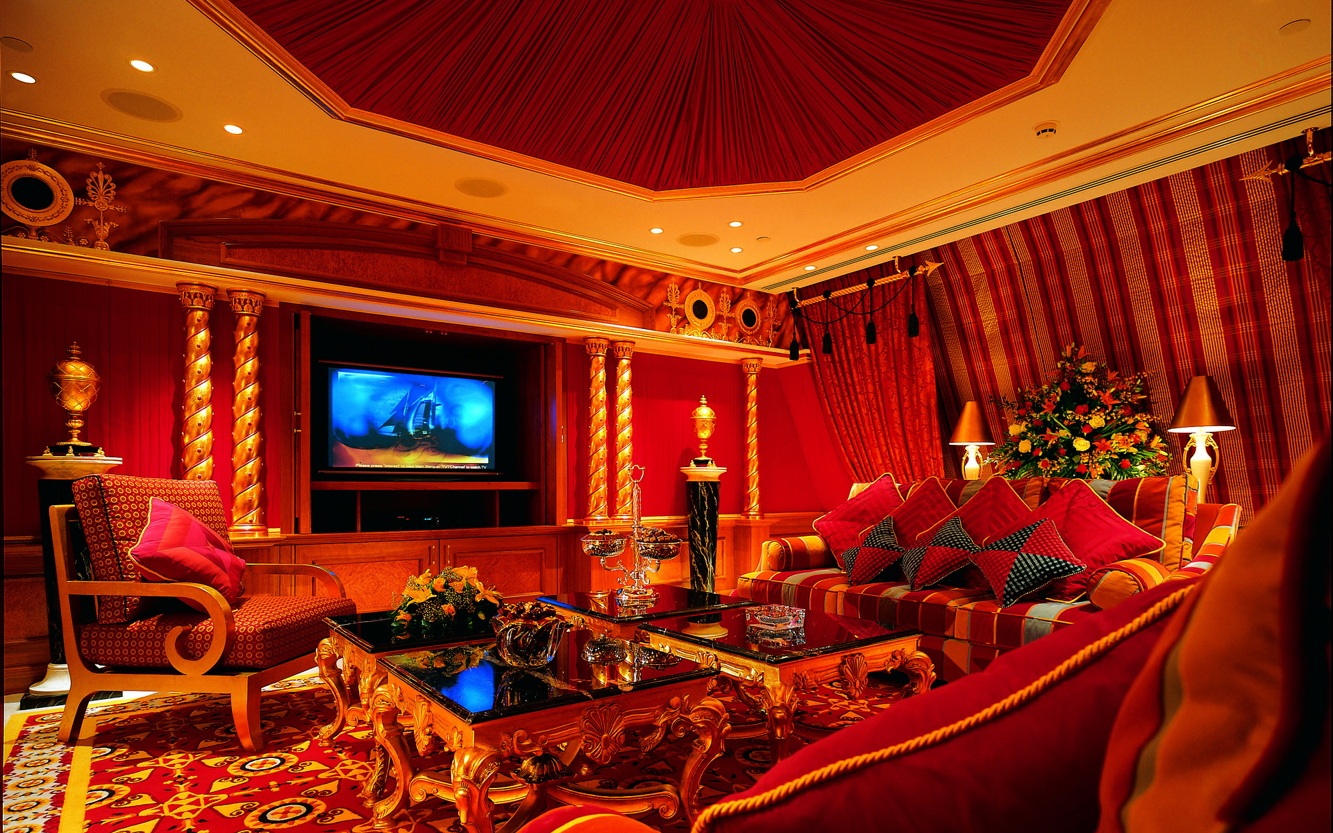 Luxurious red and gold living room with television HD Wallpaper