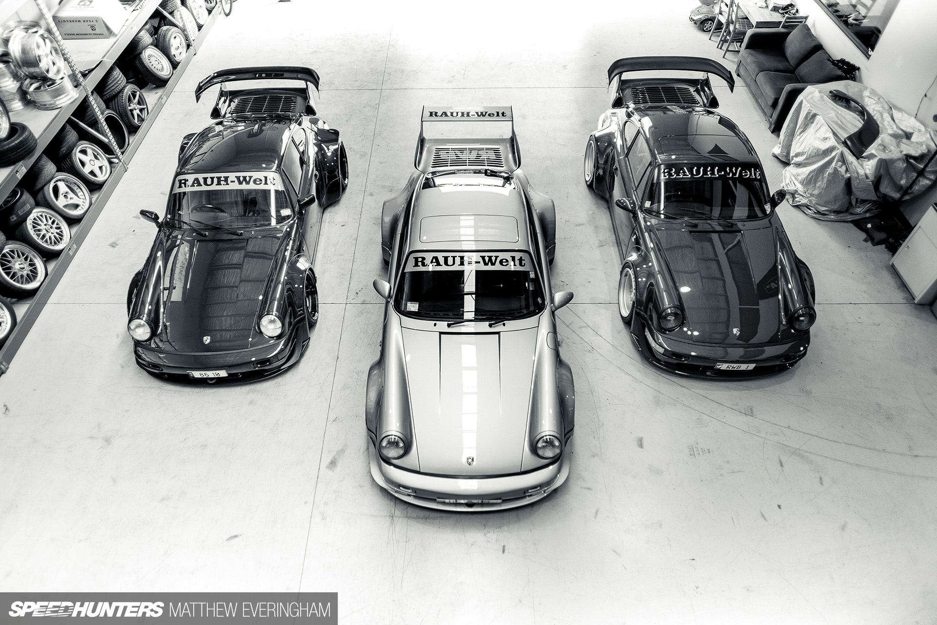Three Porsche 911 RAUH-Welt cars in a workshop HD Wallpaper