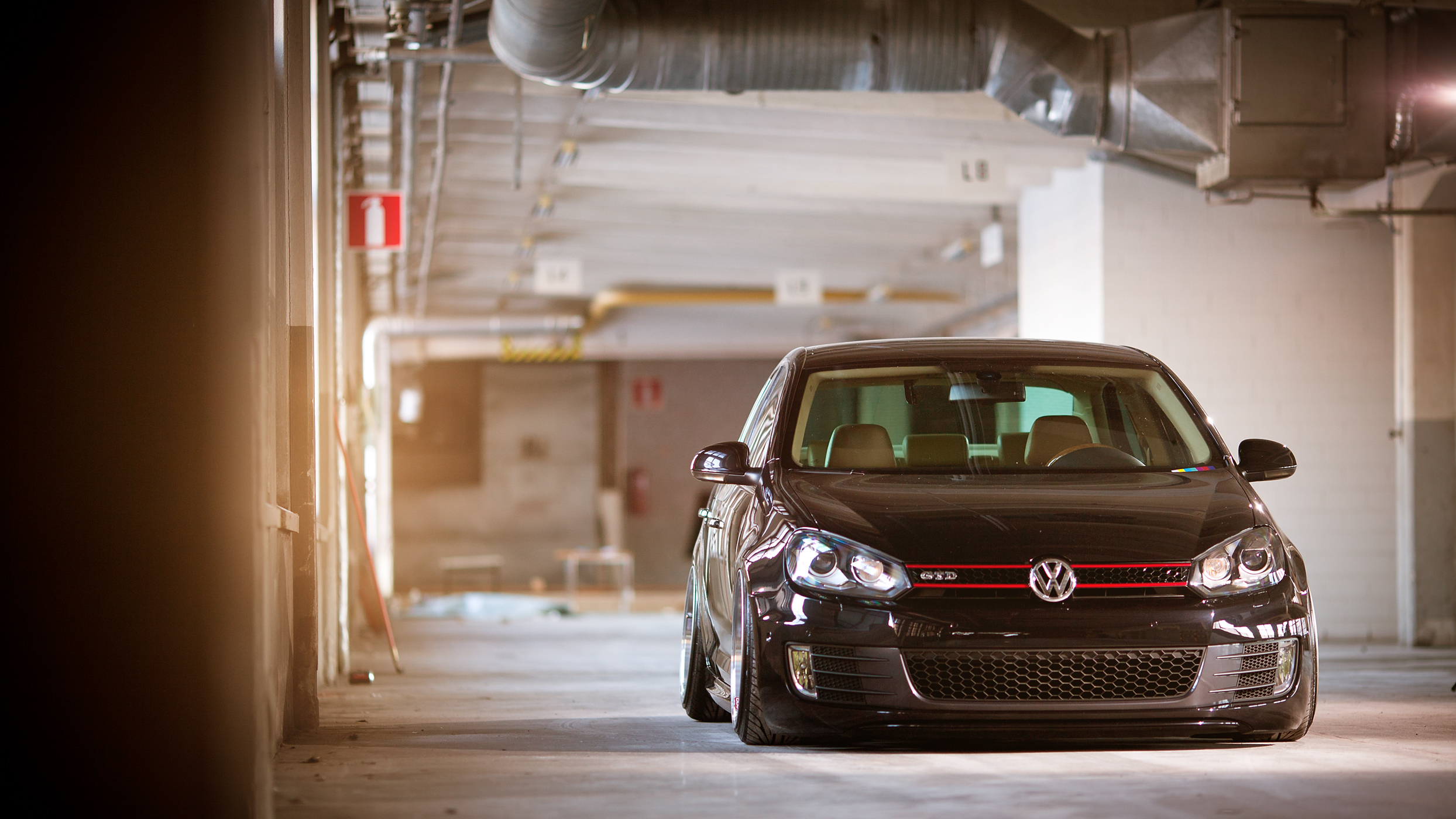 Black Volkswagen Golf GTI parked in a garage HD Wallpaper