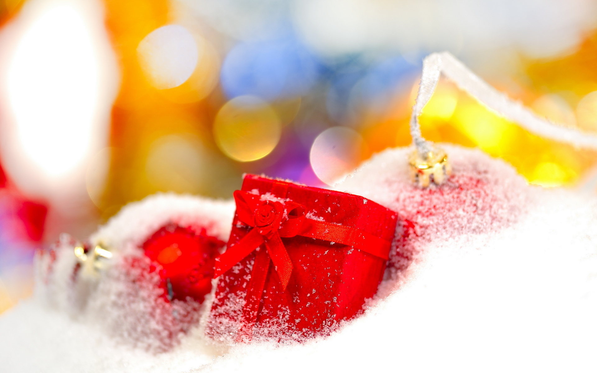 Christmas ornaments and gift box in snow HD Wallpaper