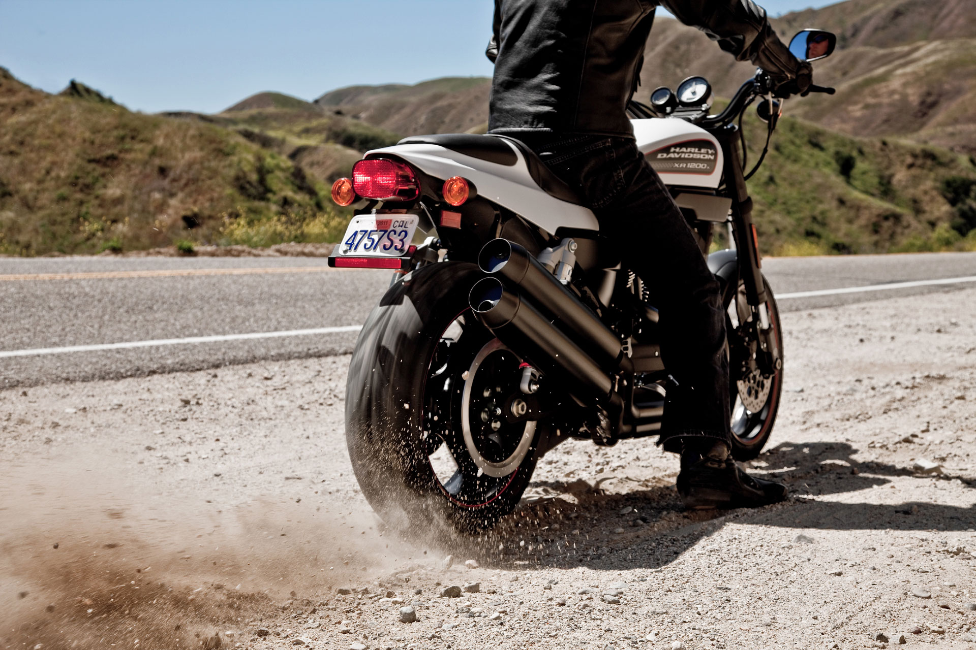 Harley-Davidson motorcycle on a dusty road HD Wallpaper