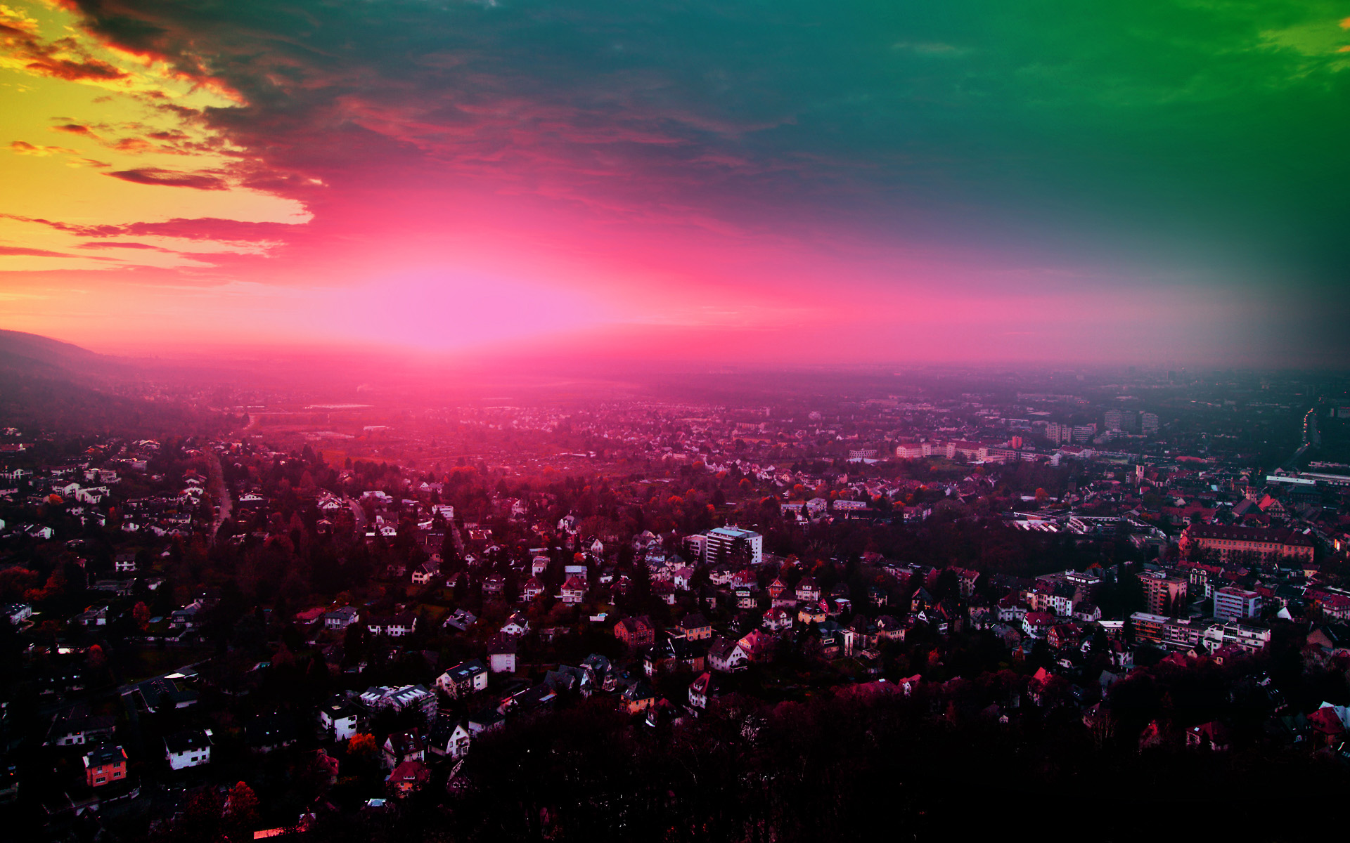 Aerial view of a city at sunset with colorful sky HD Wallpaper