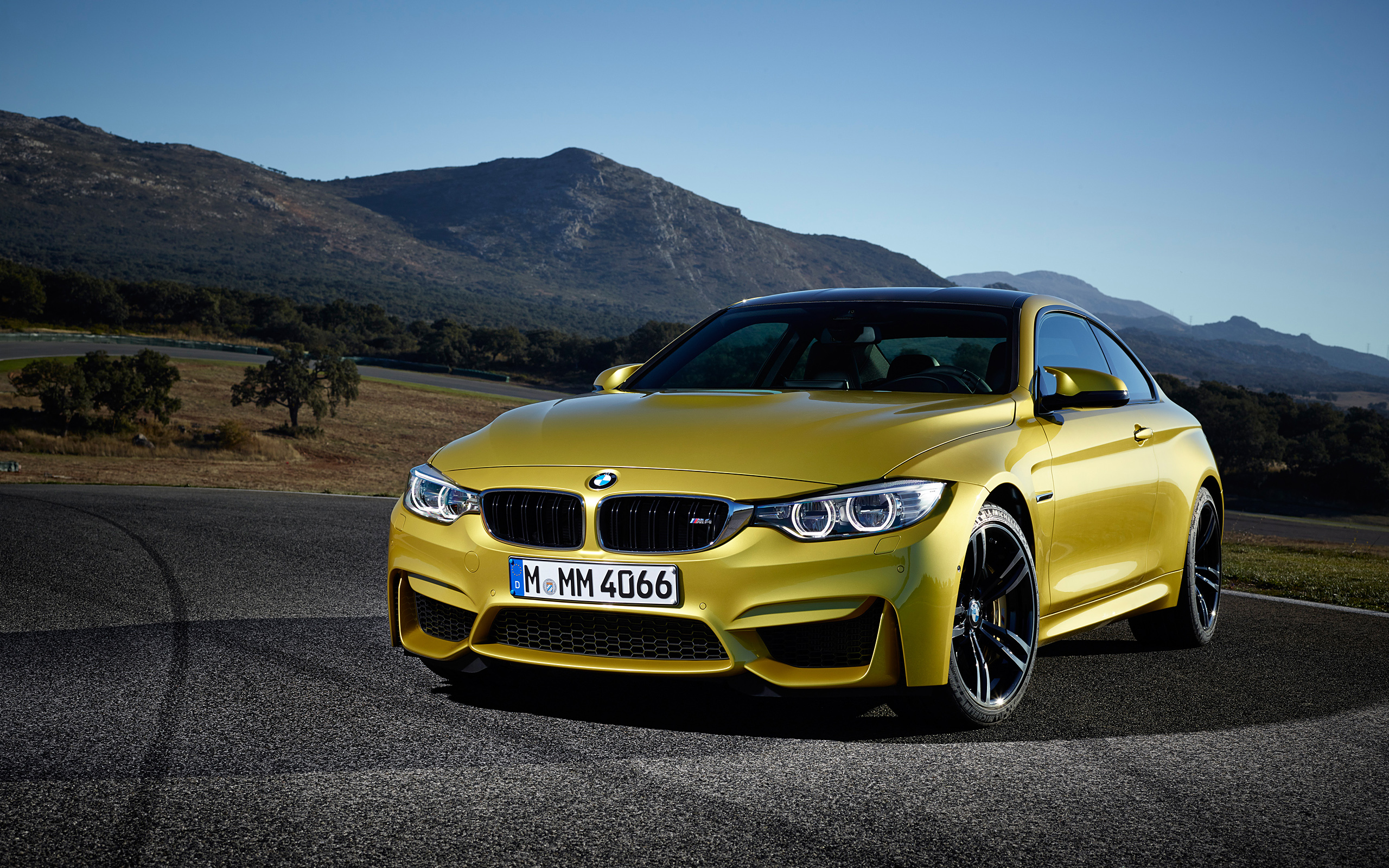 Yellow BMW M4 Coupe on a Race Track HD Wallpaper