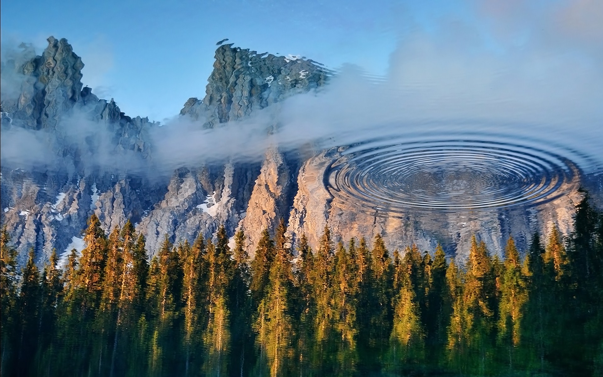 Mountain reflection in water with ripples HD Wallpaper