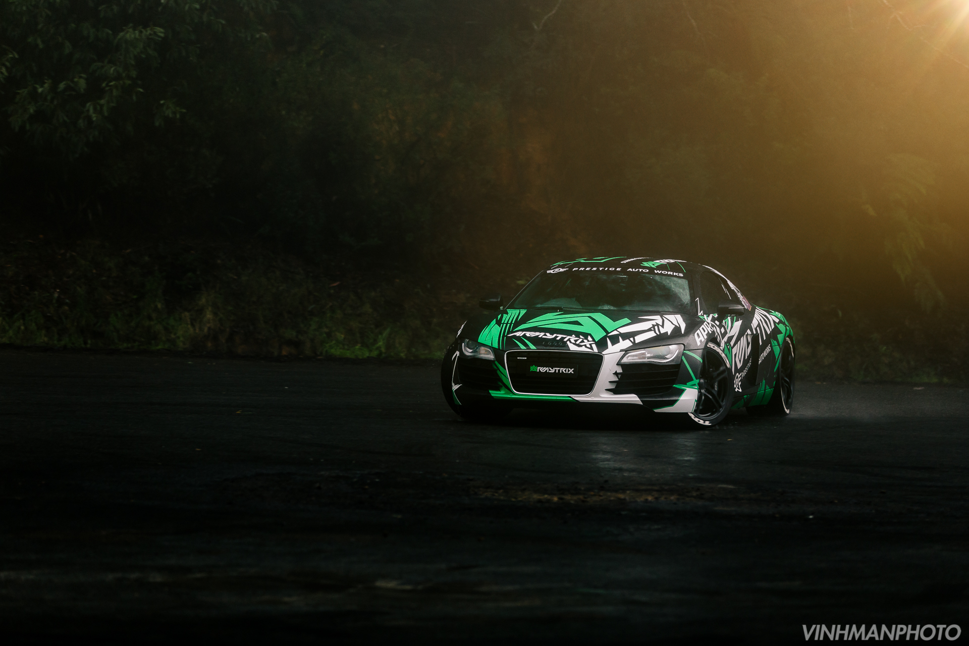 Audi R8 with green and white graphics on a wet road HD Wallpaper