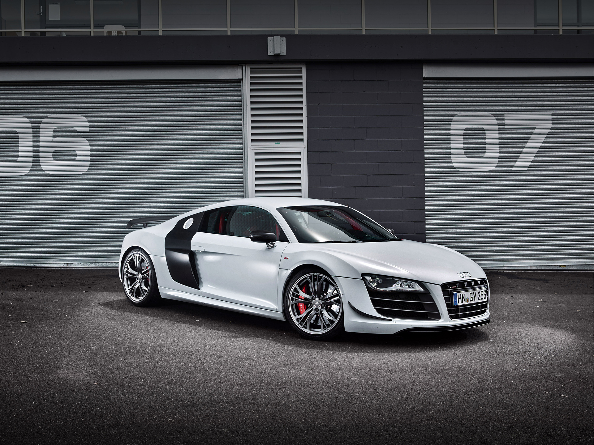 White Audi R8 parked in front of garage doors HD Wallpaper