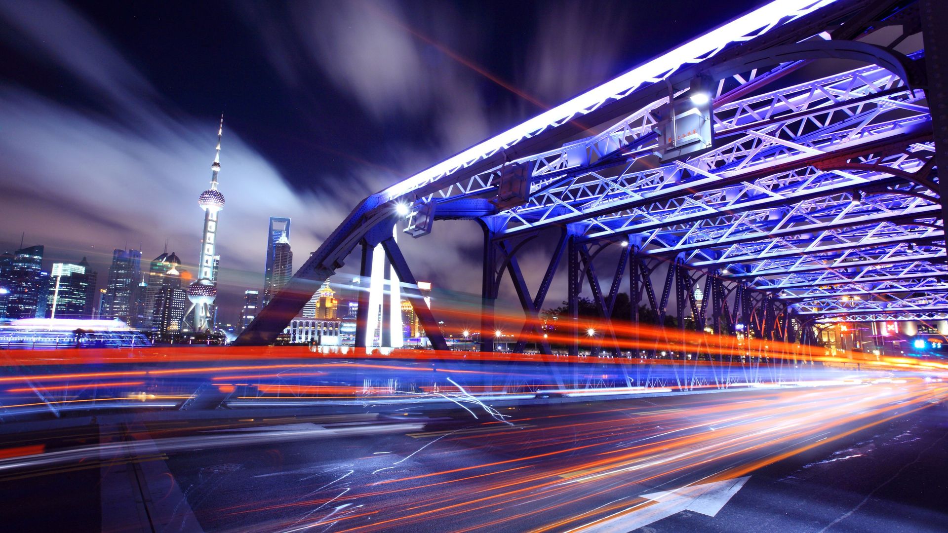 Nighttime Shanghai skyline with bridge and light trails HD Wallpaper