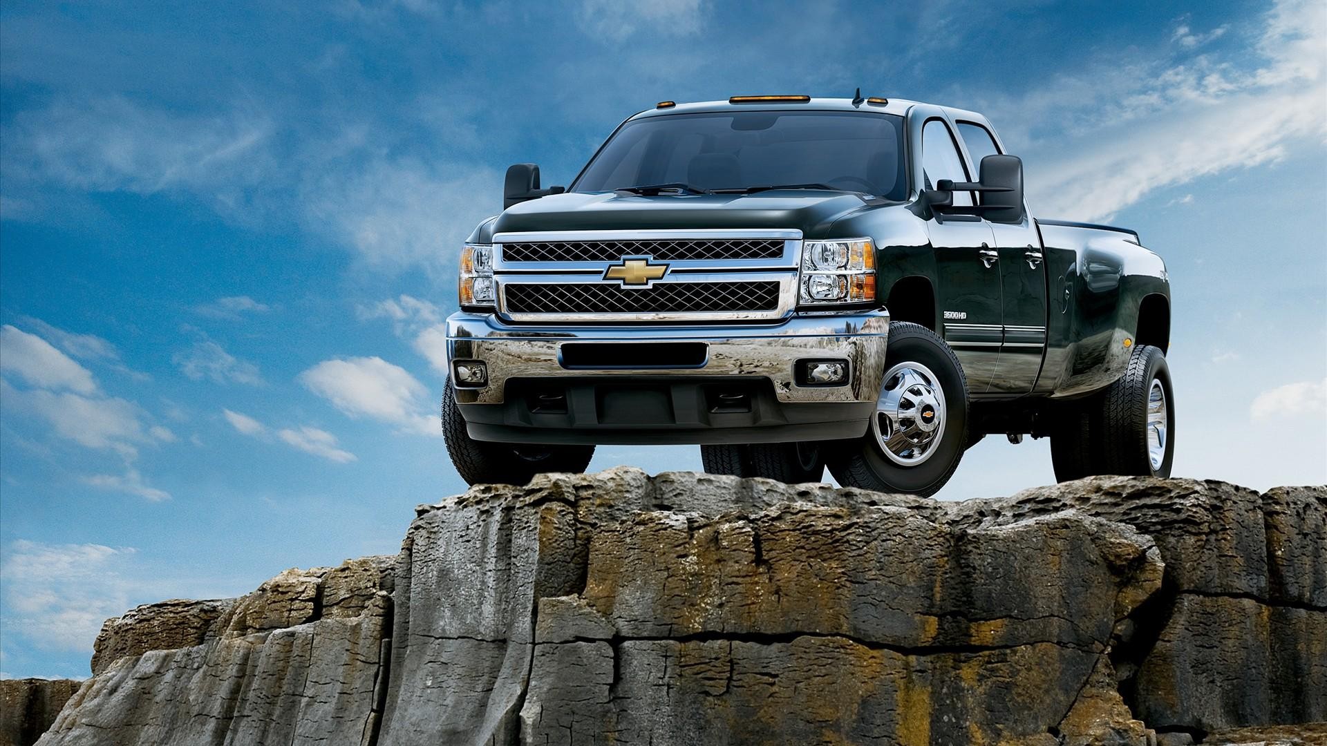 Dark Green Chevrolet Silverado Heavy Duty Truck on Rocks HD Wallpaper