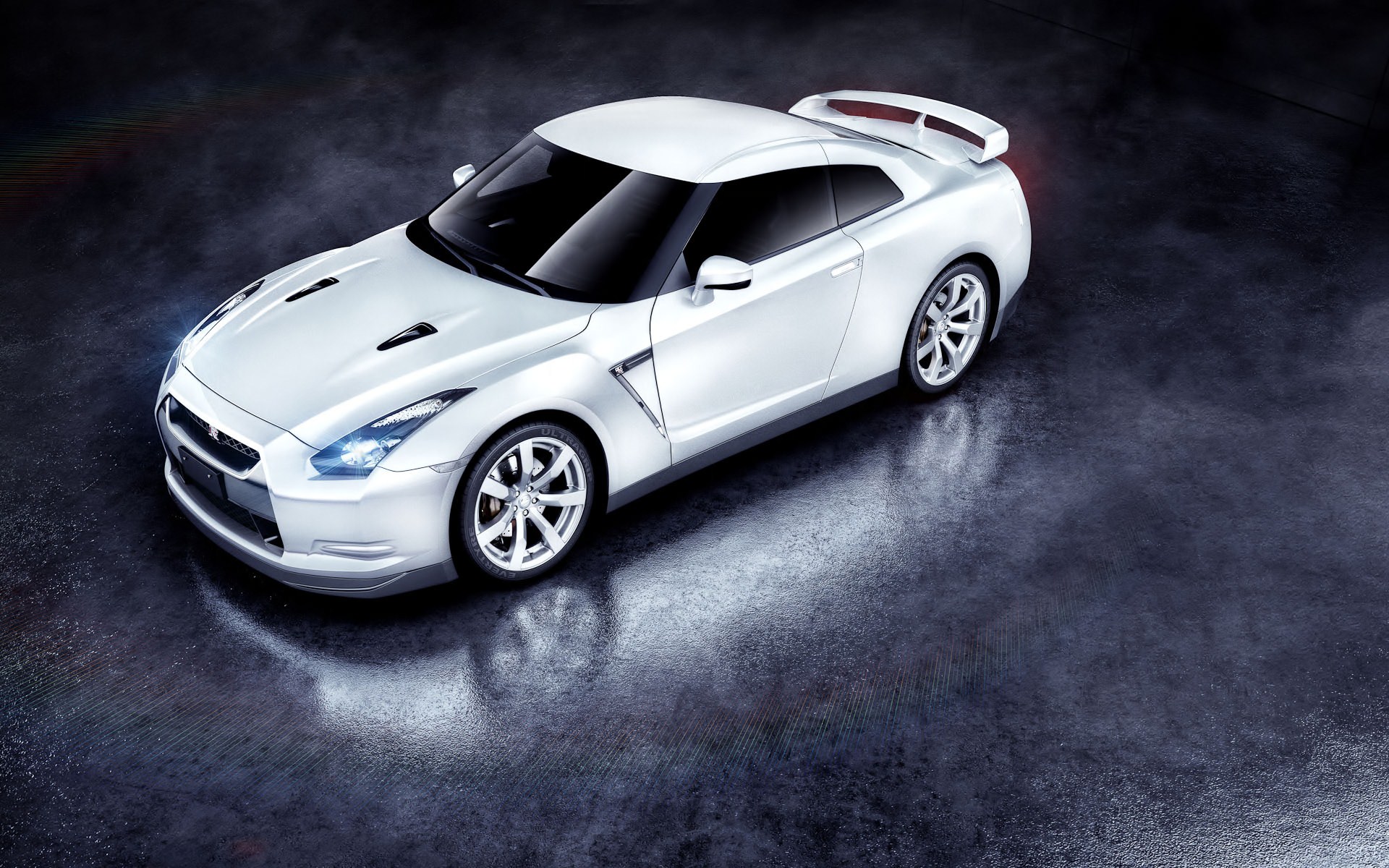 White Nissan GT-R parked on a dark surface HD Wallpaper