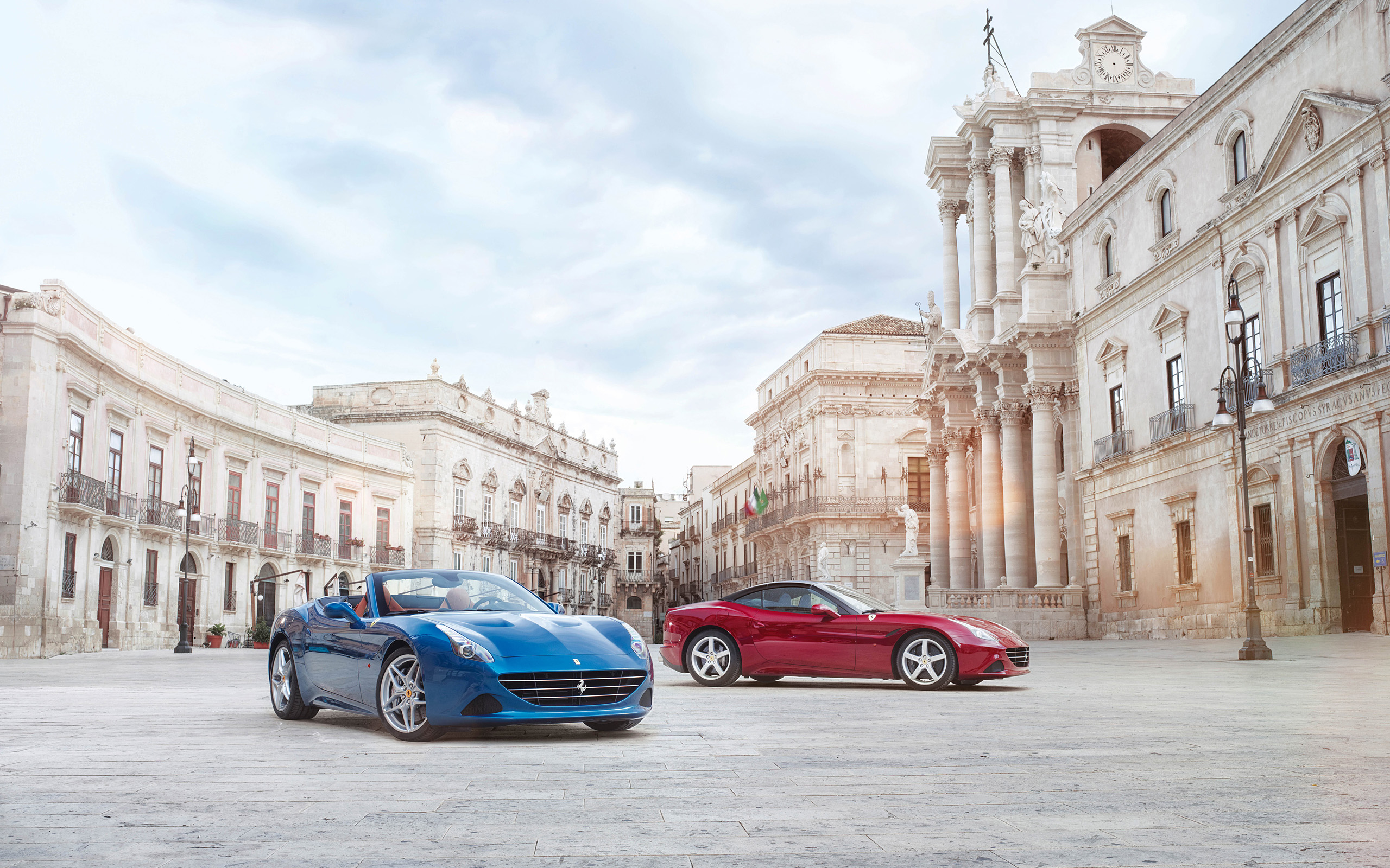 Two Ferraris in a European Square HD Wallpaper