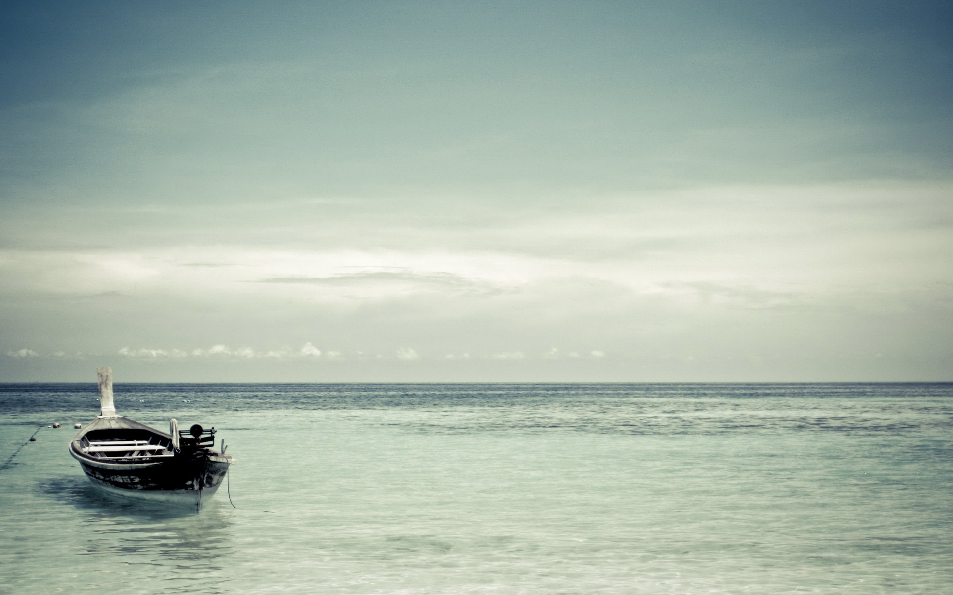 Boat floating on the ocean under a cloudy sky HD Wallpaper