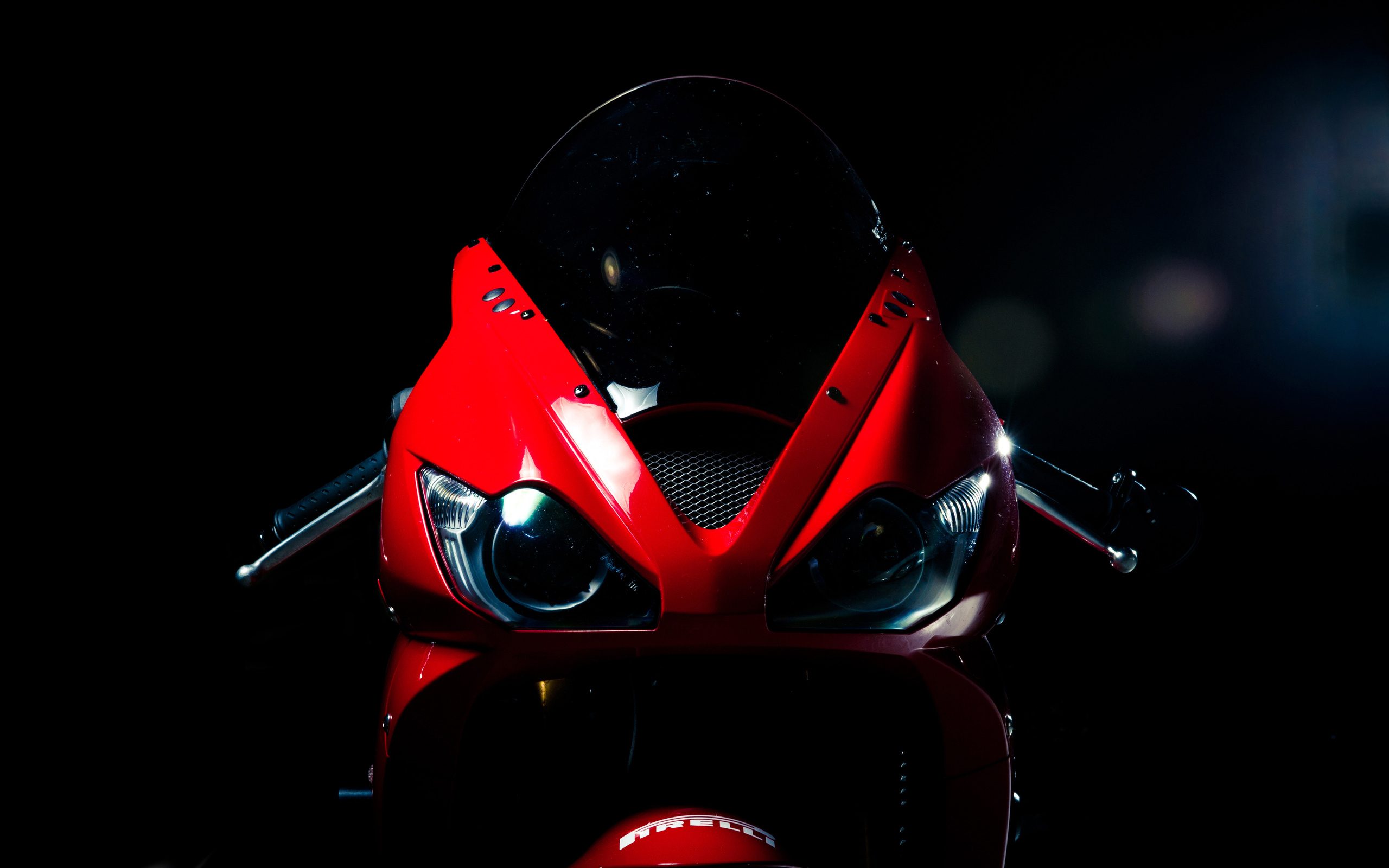 Red motorcycle front view on black background HD Wallpaper