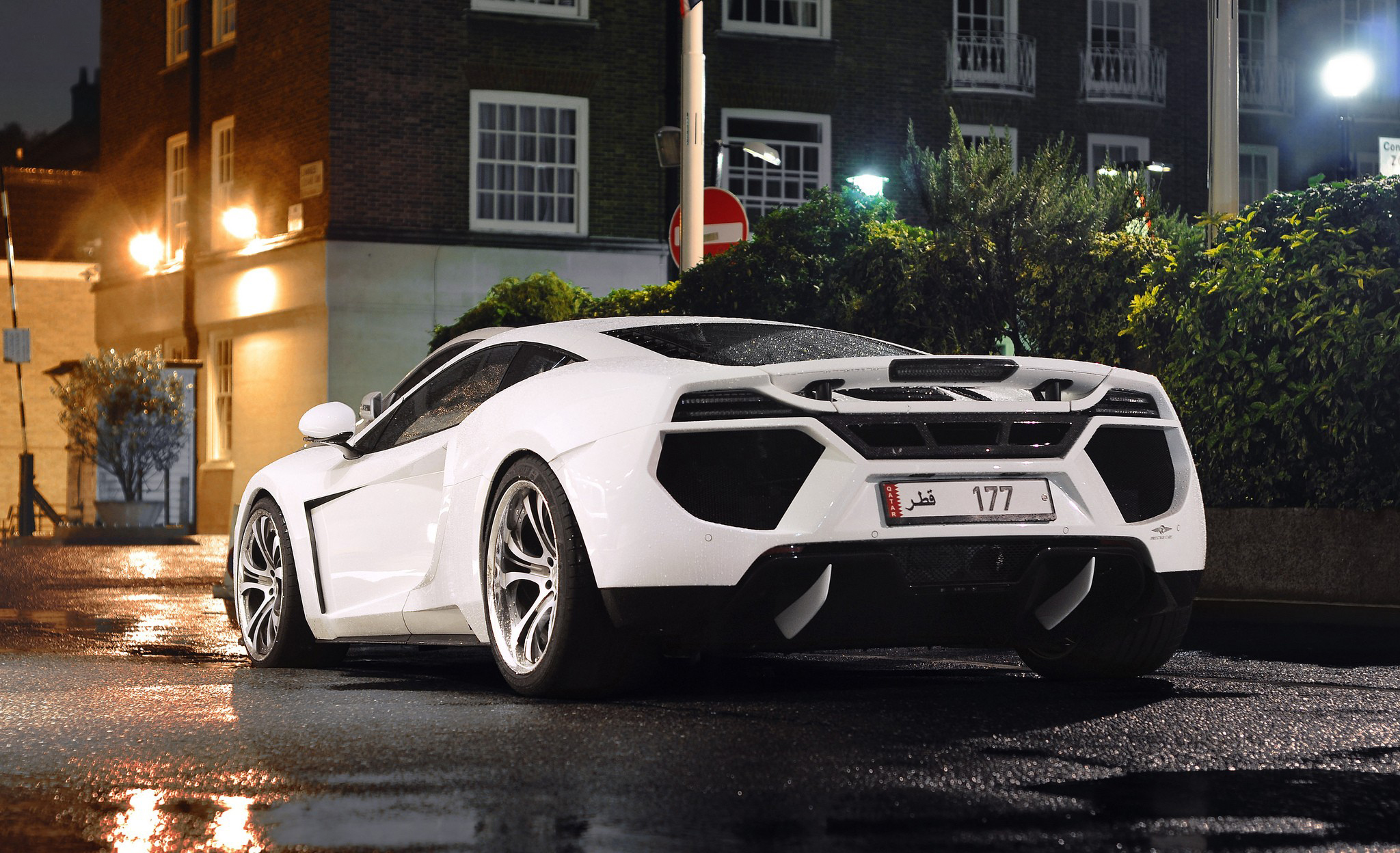 White McLaren sports car on wet street at night HD Wallpaper