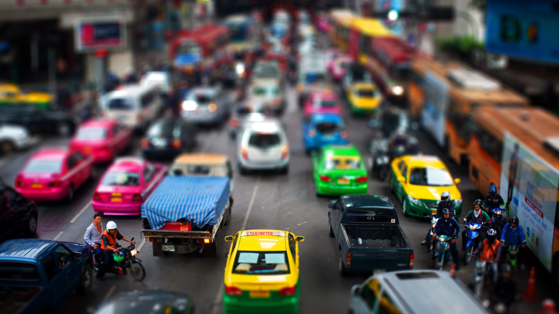 Busy city street with cars and motorcycles HD Wallpaper