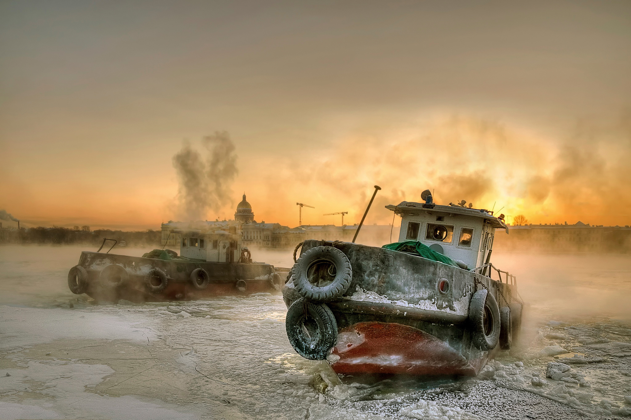 Two tugboats in icy water at sunrise HD Wallpaper