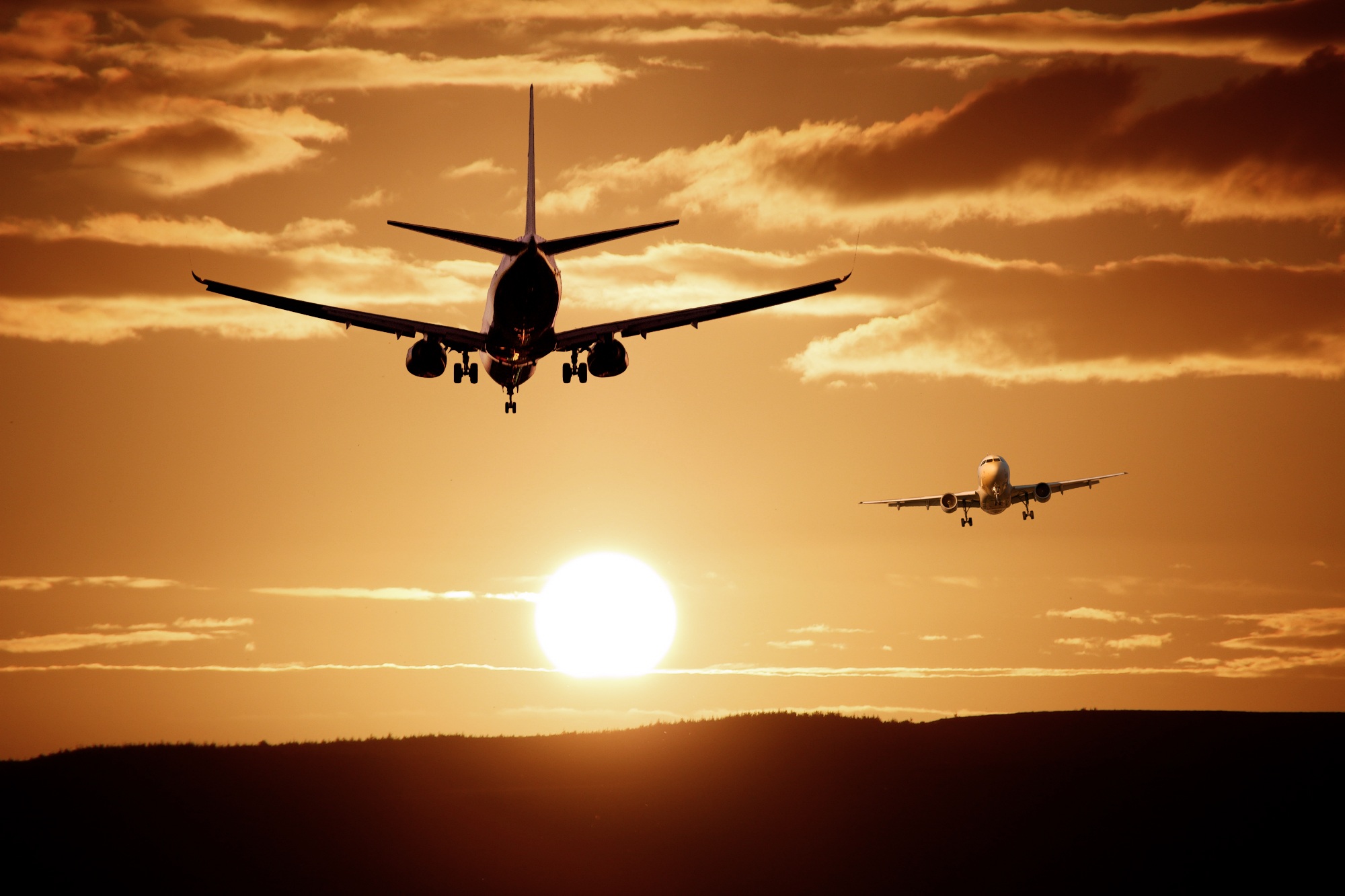 Two airplanes flying at sunset HD Wallpaper