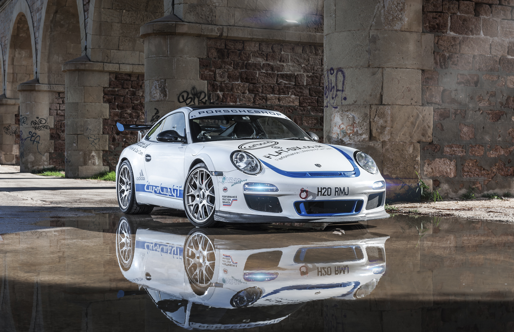 White Porsche race car with blue stripes HD Wallpaper