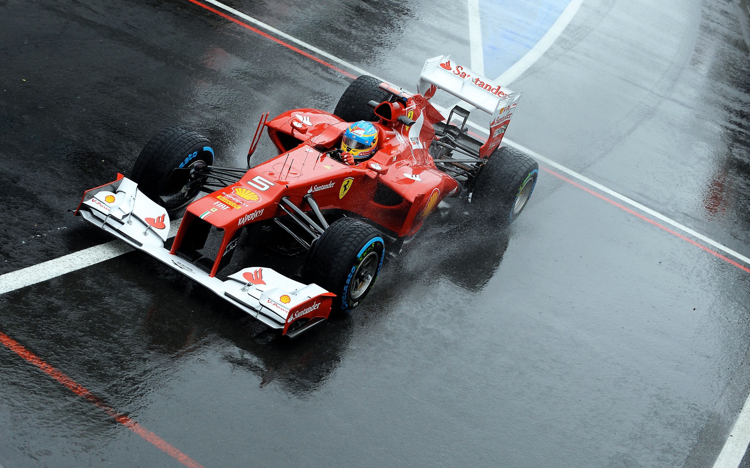 Fernando Alonso driving a Ferrari Formula 1 car in the rain HD Wallpaper