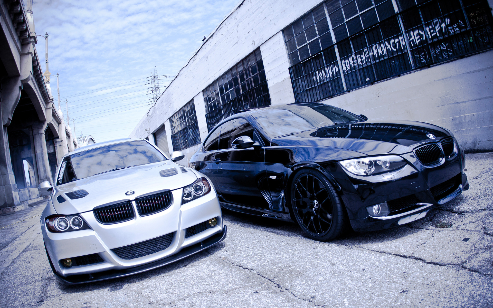 Two BMW coupes parked on a street HD Wallpaper