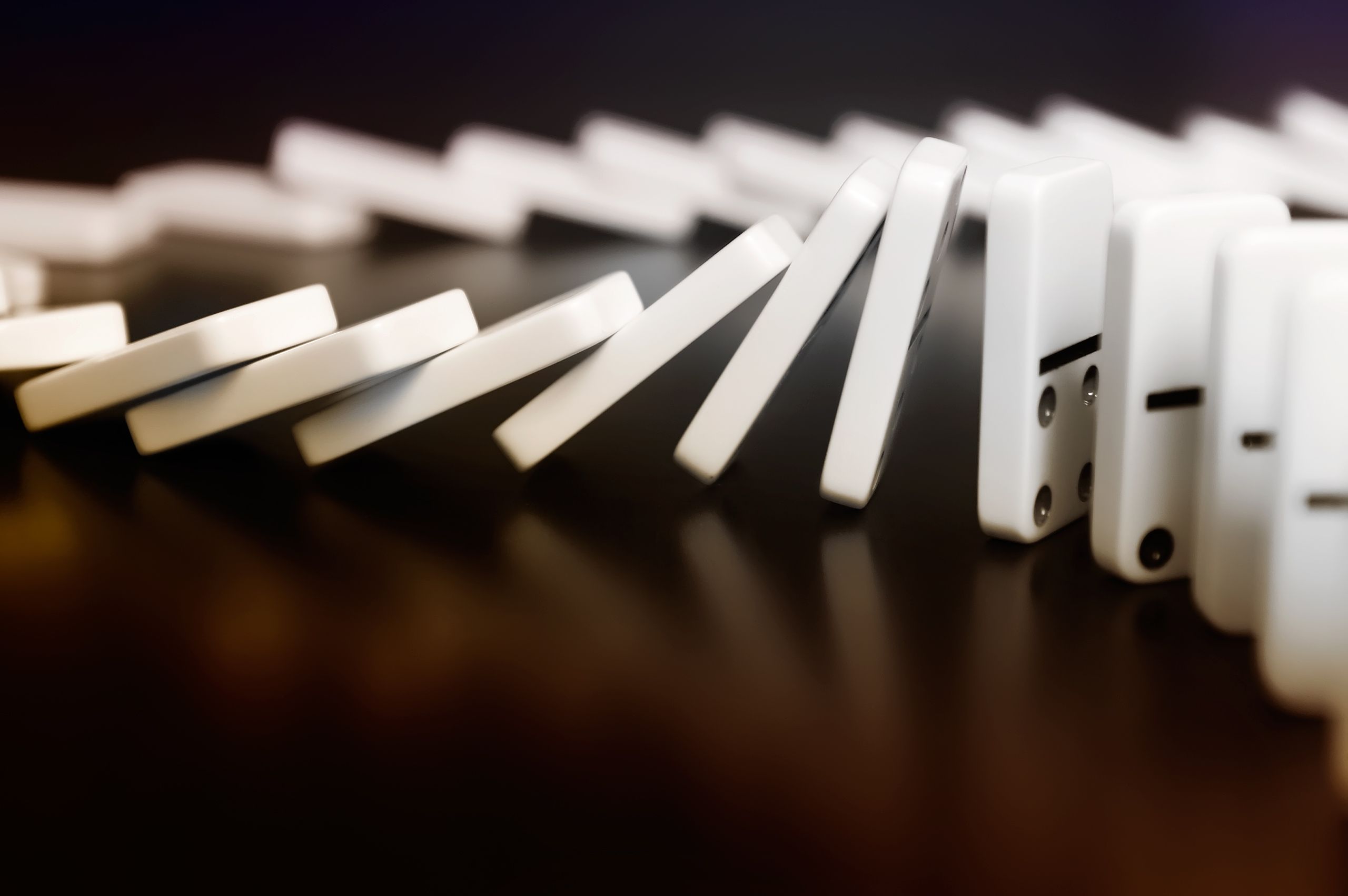 White dominoes falling in a line HD Wallpaper
