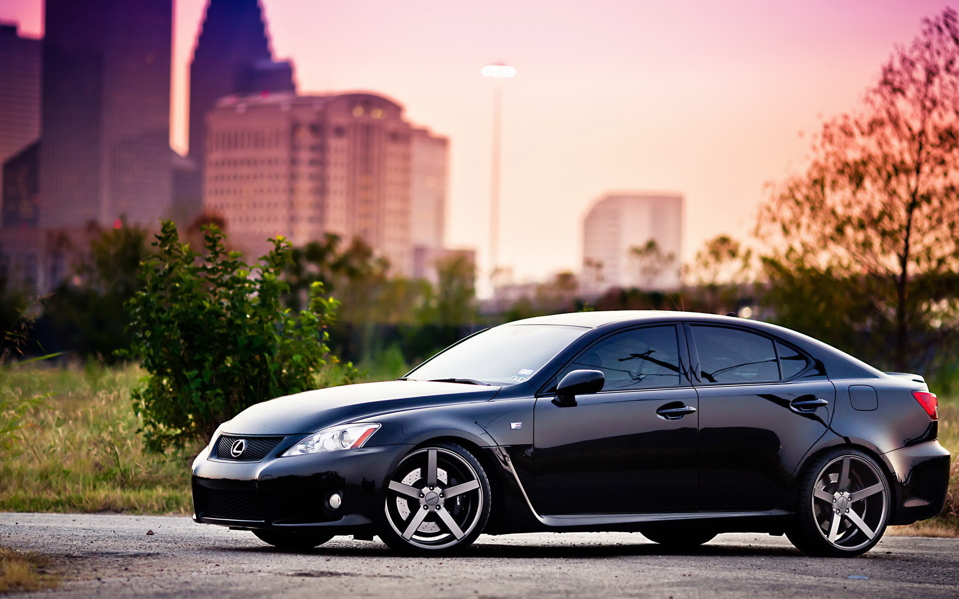Black Lexus IS sedan with custom wheels in city at sunset HD Wallpaper