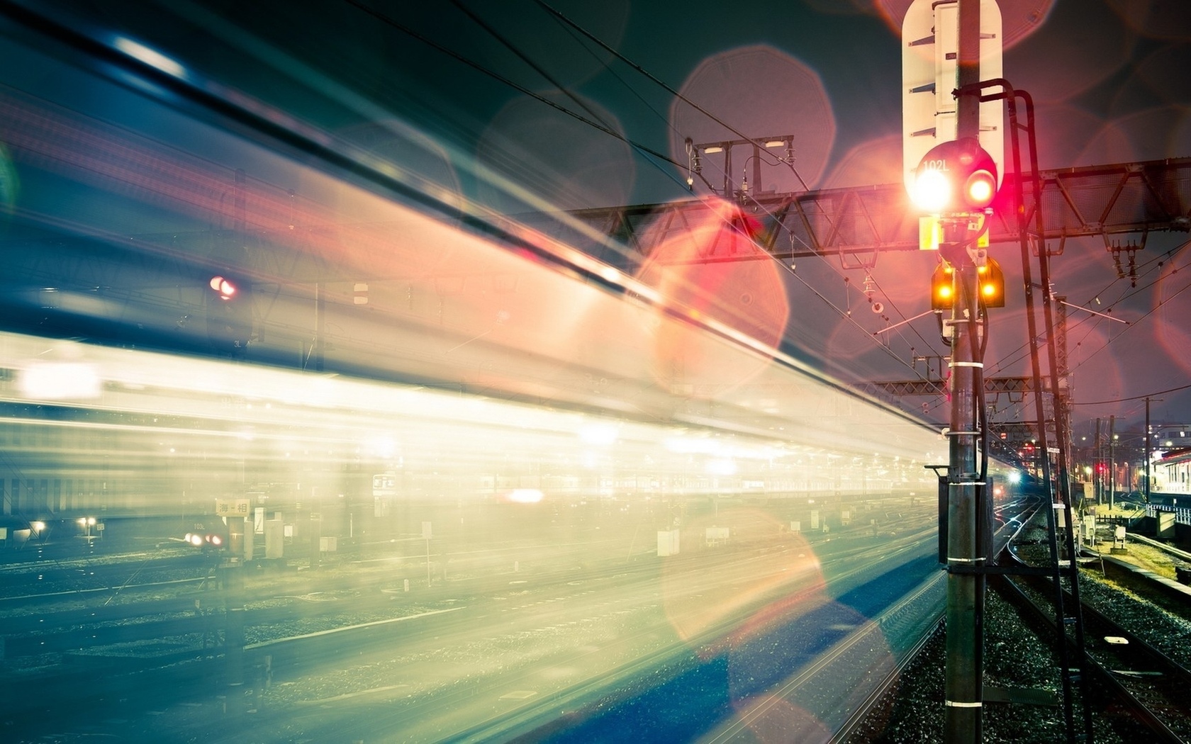 Time-lapse photography of a train at night with signal lights HD Wallpaper