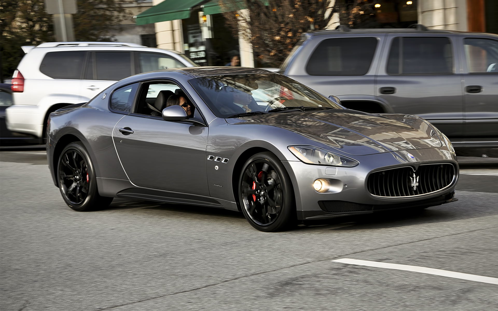 Maserati GranTurismo driving on a street HD Wallpaper
