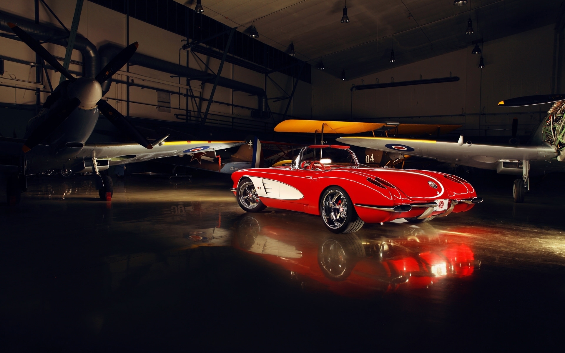 Red 1950s Corvette in hangar with airplanes HD Wallpaper